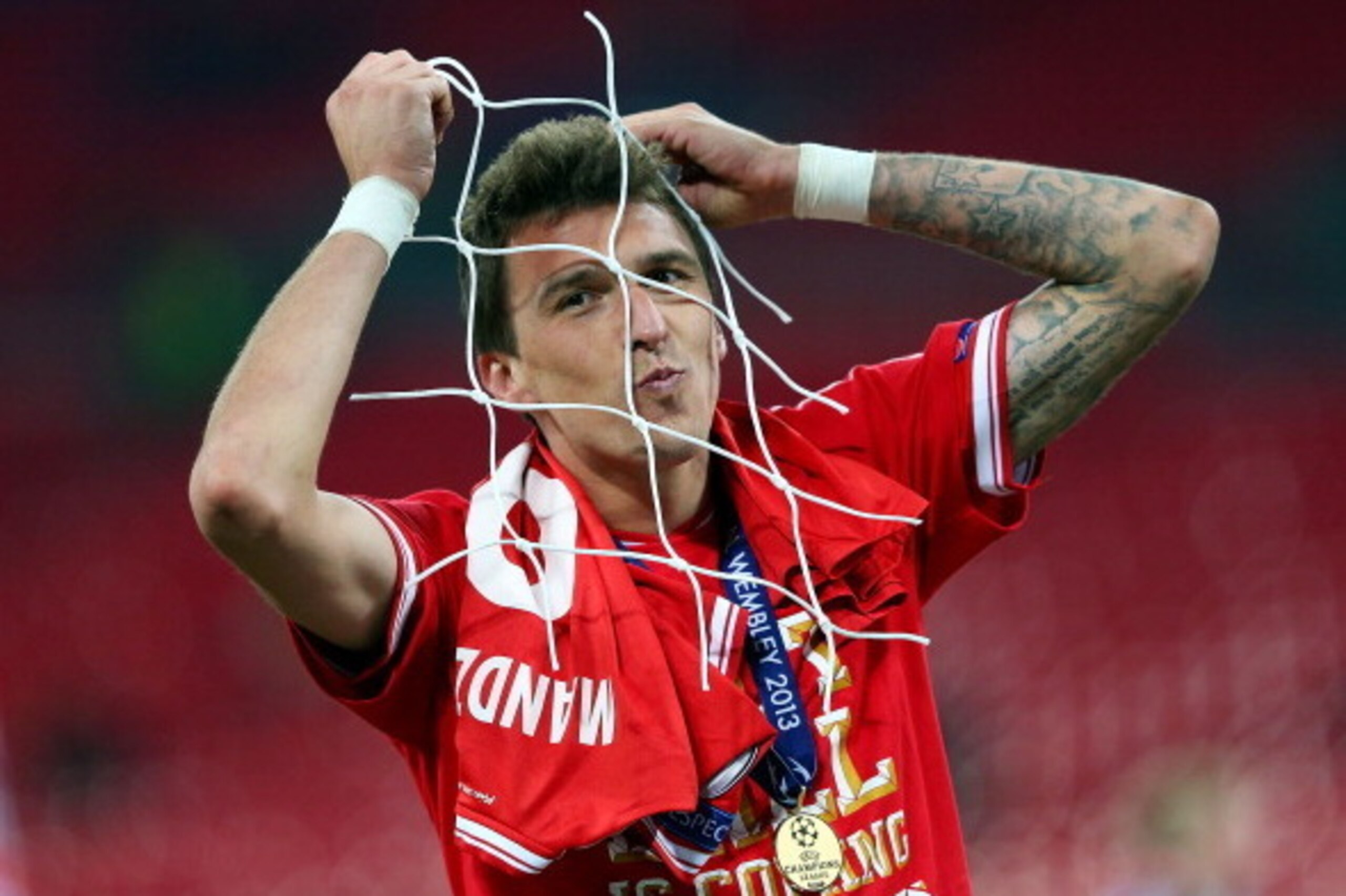 LONDON, ENGLAND - MAY 25:  Mario Mandzukic of Bayern Muenchen celebrates with a piece of goal netting after winning the UEFA Champions League final match against Borussia Dortmund at Wembley Stadium on May 25, 2013 in London, United Kingdom.  (Photo by Al