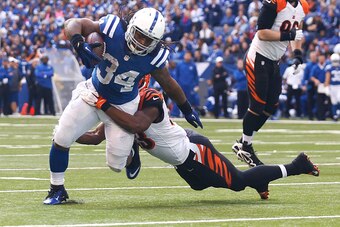 INDIANAPOLIS, IN - OCTOBER 19:  Marquis Flowers #53 of the Cincinnati Bengals tackles Trent Richardson #34 of the Indianapolis Colts during the fourth quarter on October 19, 2014 at Lucas Oil Stadium on October 19, 2014 in Indianapolis, Indiana. Indianapo