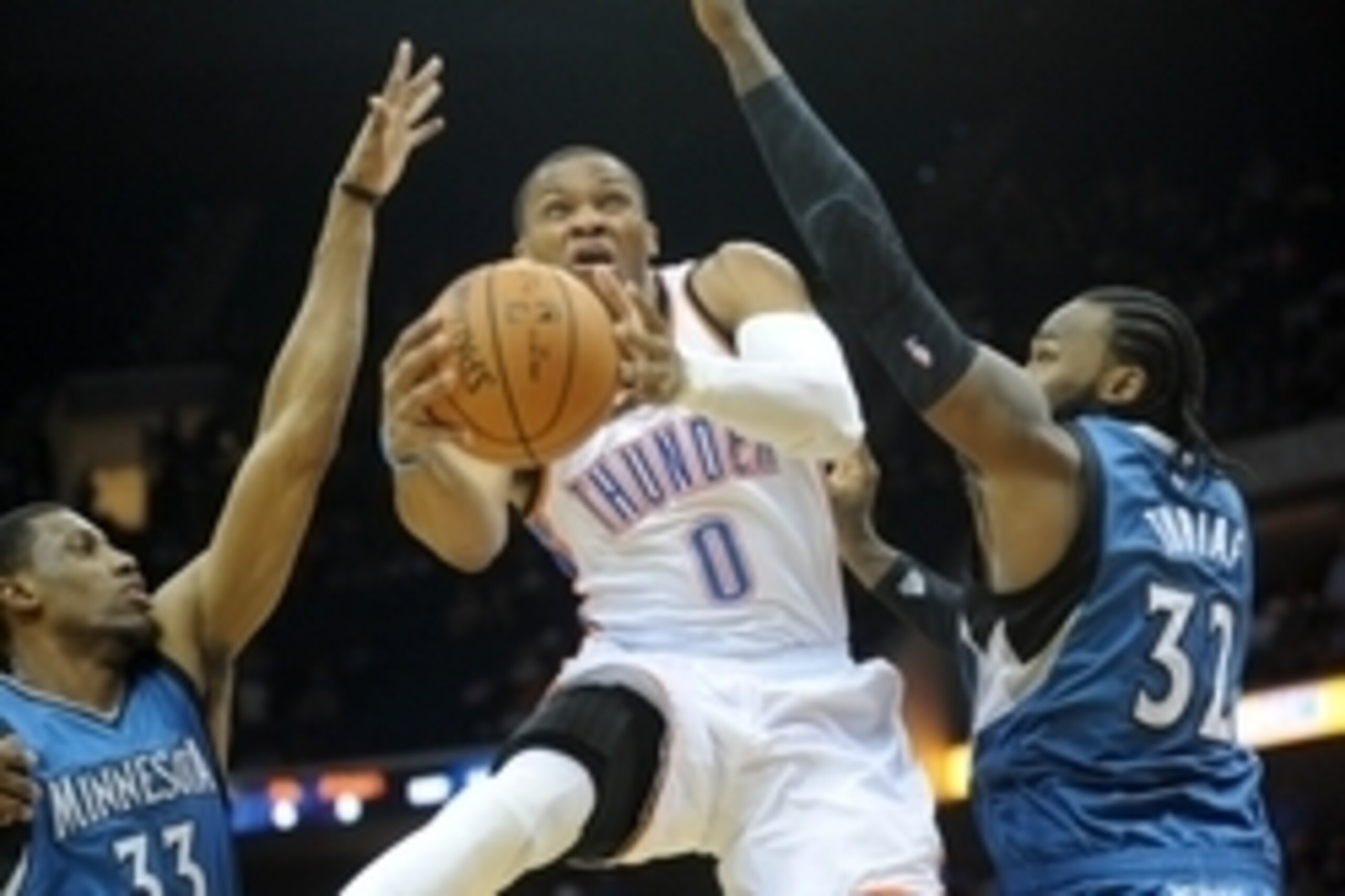 Oct 19, 2014; Tulsa, OK, USA; Oklahoma City Thunder guard Russell Westbrook (0) attempts a shot against Minnesota Timberwolves forward Thaddeus Young (33) and Minnesota Timberwolves center Ronny Turiaf (32) during the first quarter at BOK Center. Mandator
