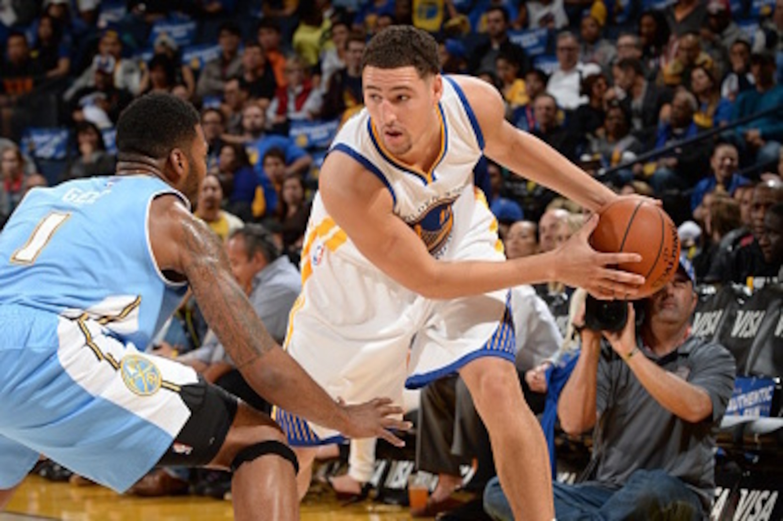 Oakland, CA- OCTOBER 24: Klay Thompson #11 of the Golden State Warriors handles the ball against the Denver Nuggets at the Oracle Arena in Oakland, California on October 24, 2014 . NOTE TO USER: User expressly acknowledges and agrees that, by downloading 