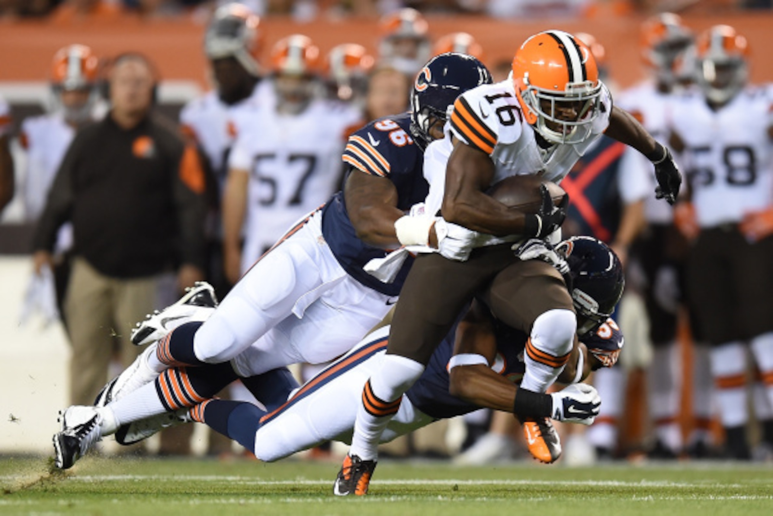CLEVELAND, OH - AUGUST 28:  Andrew Hawkins #16 of the Cleveland Browns gets dragged down by Christian Jones #96 and Al Louis-Jean #39 of the Chicago Bears during the first quarter at FirstEnergy Stadium on August 28, 2014 in Cleveland, Ohio.  (Photo by Jo