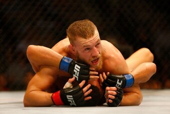 BOSTON, MA - AUGUST 17: Conor McGregor pins down Max Holloway in their featherweight bout at TD Garden on August 17, 2013 in Boston, Massachusetts. (Photo by Jared Wickerham/Getty Images)
