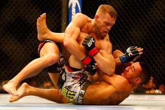BOSTON, MA - AUGUST 17: Conor McGregor elbows Max Holloway on the ground in their featherweight bout at TD Garden on August 17, 2013 in Boston, Massachusetts. (Photo by Jared Wickerham/Getty Images)