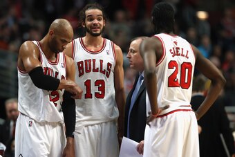 CHICAGO, IL - JANUARY 24: (L-R) Taj Gibson #22, Joakim Noah #13 and Tony Snell #20 of the Chicago Bulls listen to head coach Tom Thibodeau during a time out against the Los Angeles Clippers at the United Center on January 24, 2014 in Chicago, Illinois. Th