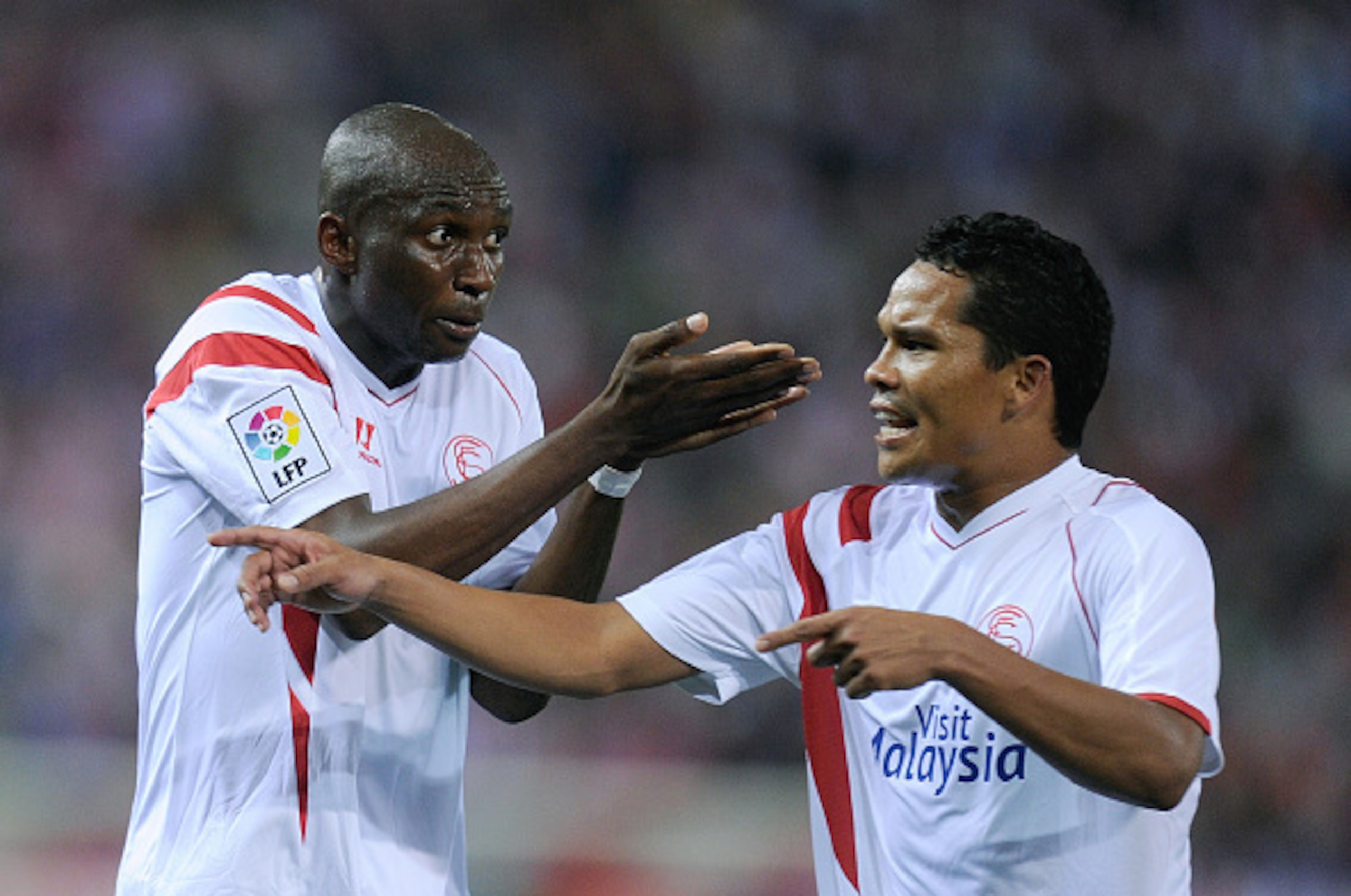 MADRID, SPAIN - SEPTEMBER 27:  Stephane Mbia (L) and Carlos Bacca of Sevilla FC argue during the La Liga match between Club Atletico de Madrid and Sevilla FC at Vicente Calderon Stadium on September 27, 2014 in Madrid, Spain.  (Photo by Denis Doyle/Getty 