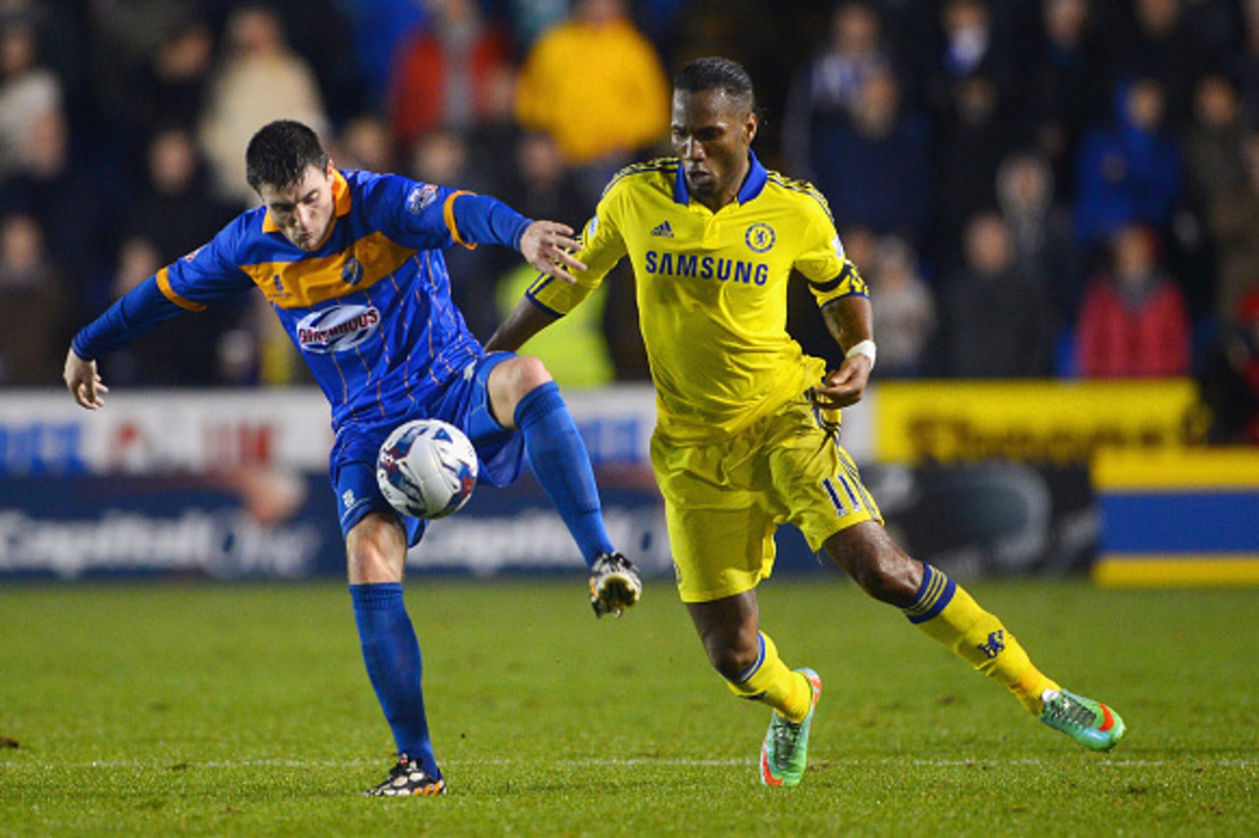 SHREWSBURY, ENGLAND - OCTOBER 28: Didier Drogba of Chelsea marshalls Bobby Grant of Shrewsbury Town during the Capital One Cup Fourth Round match between Shrewsbury Town and Chelsea at Greenhous Meadow on October 28, 2014 in Shrewsbury, England.  (Photo b