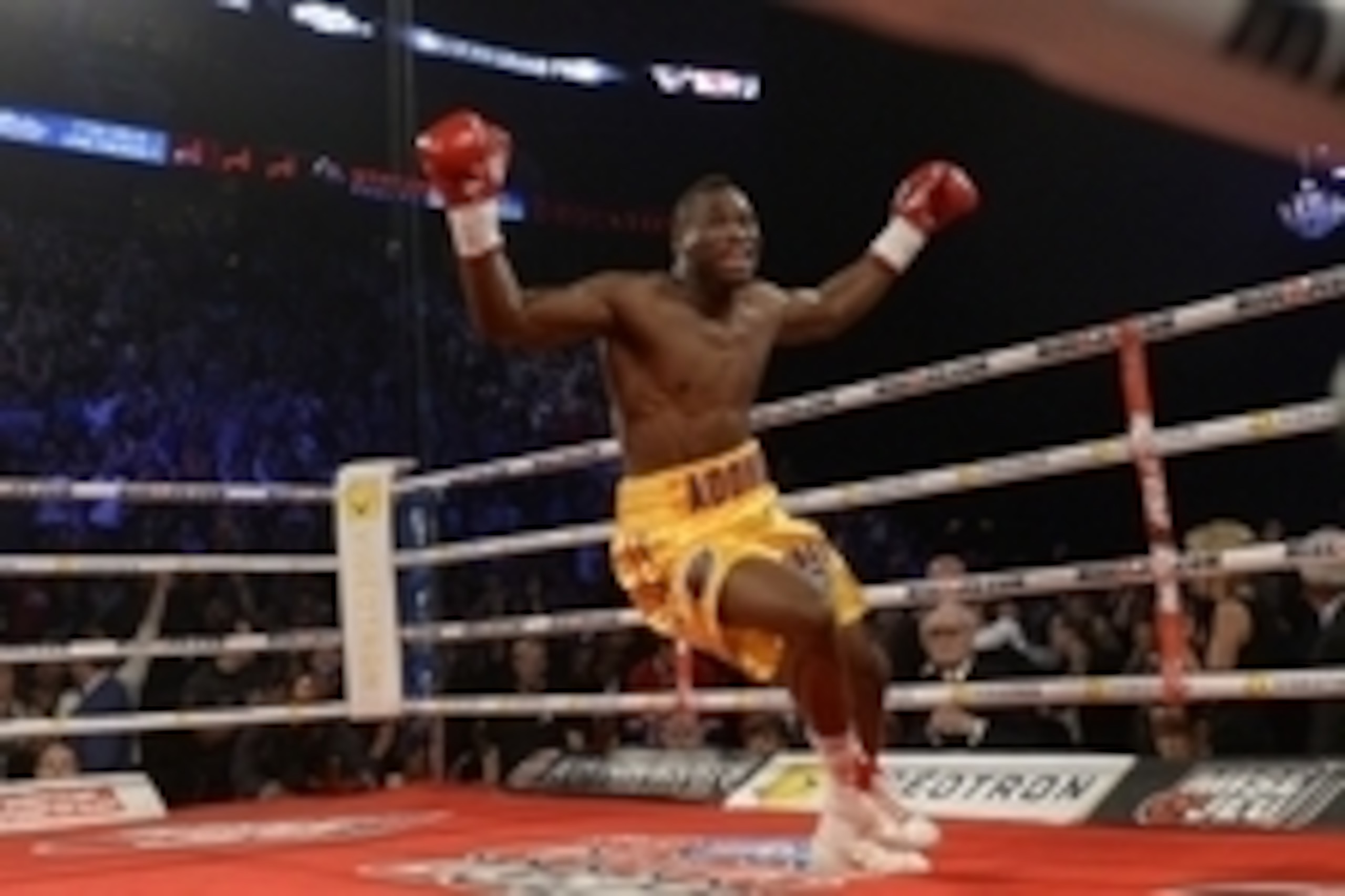 Jun 8, 2013; Montreal, Quebec, Canada; Adonis Stevenson (gold/yellow) celebrates after knocking out Chad Dawson (not pictured) during the first round of their light heavyweight  WBC title bout at the Bell Centre. Mandatory Credit: Eric Bolte-USA TODAY Spo