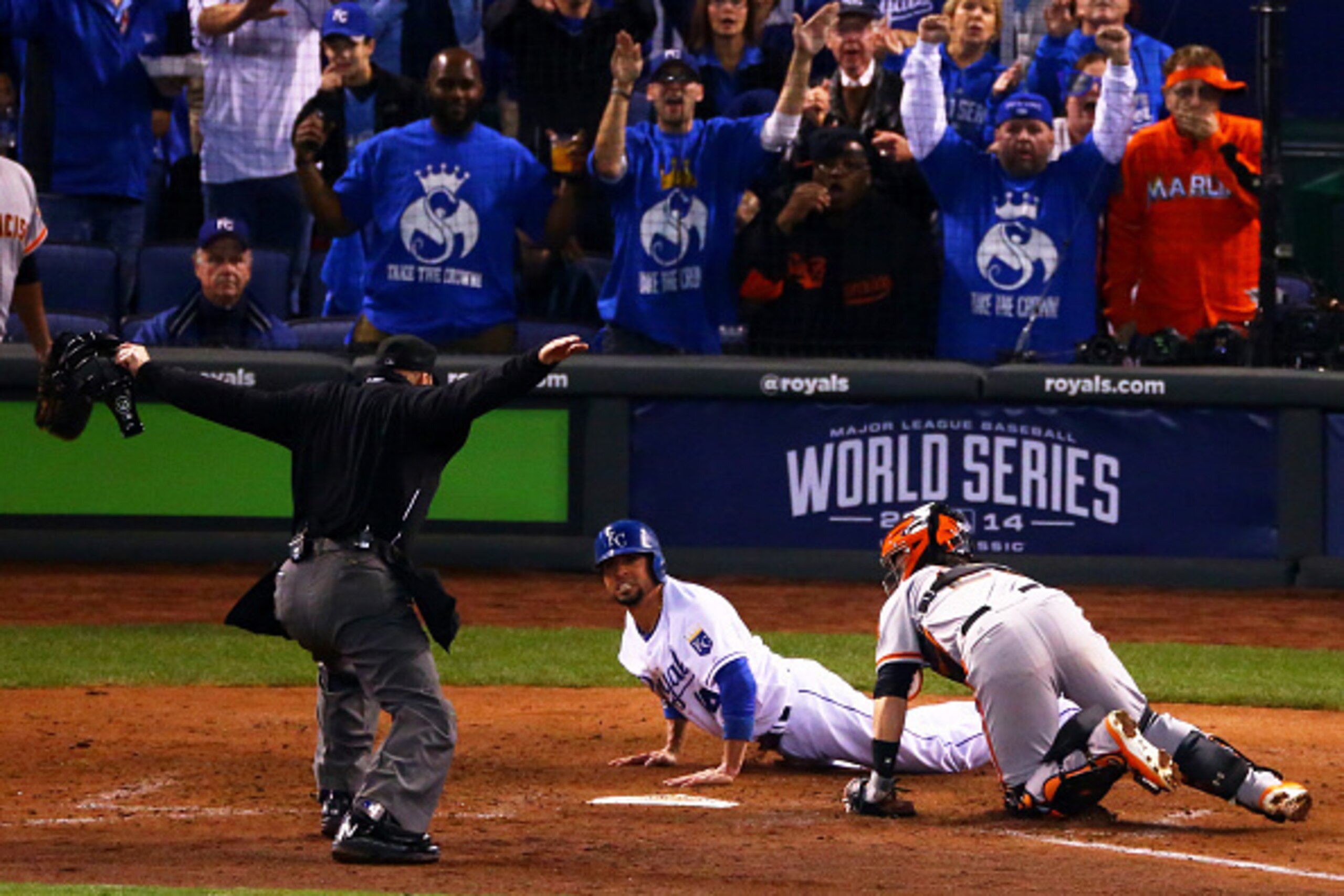 KANSAS CITY, MO - OCTOBER 28:  Omar Infante #14 of the Kansas City Royals sildes into home to score in the fifth inning against Buster Posey #28 of the San Francisco Giants during Game Six of the 2014 World Series at Kauffman Stadium on October 28, 2014 i