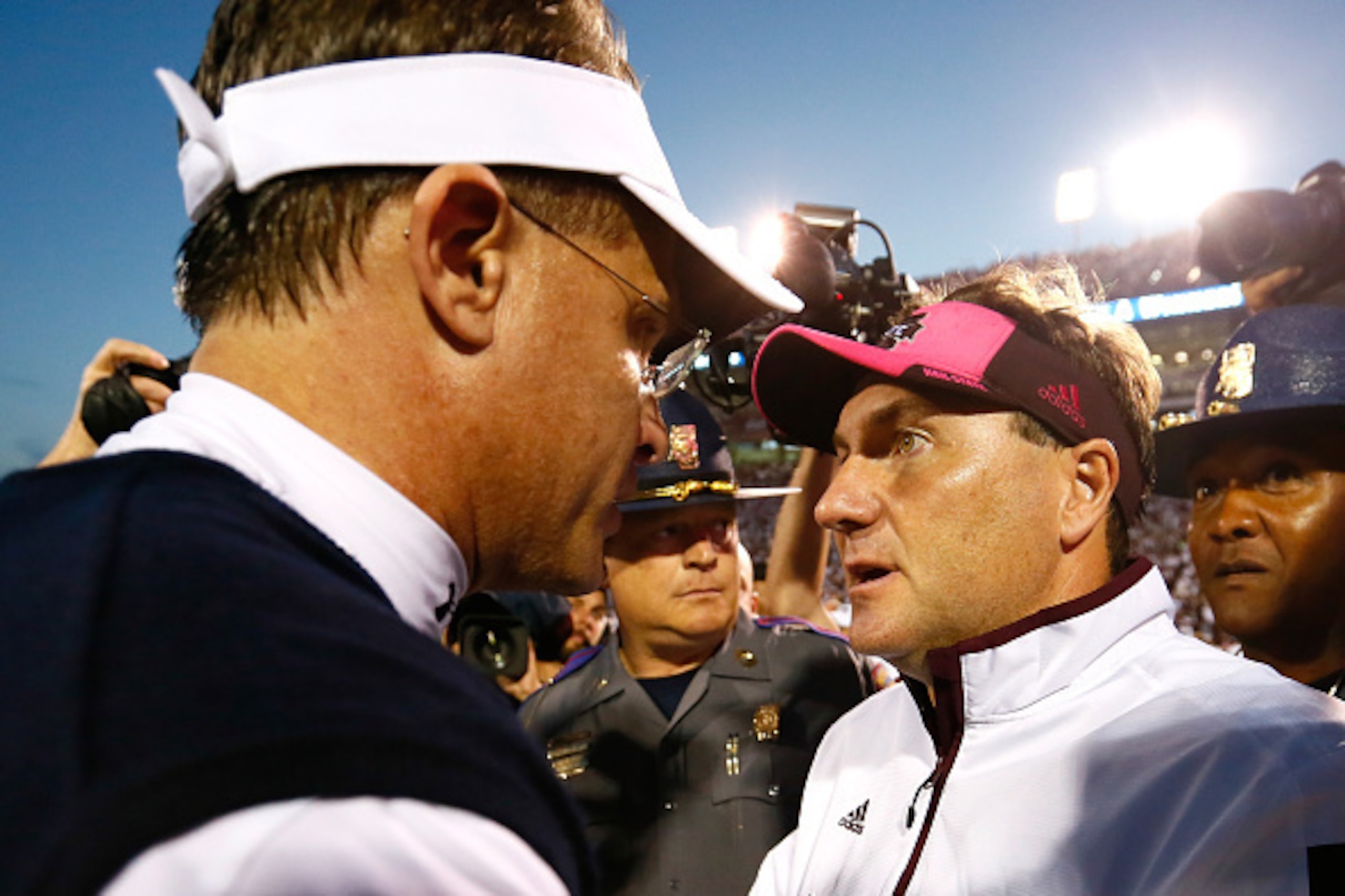 STARKVILLE, MS - OCTOBER 11:  Head coach Dan Mullen of the Mississippi State Bulldogs shakes hands with head coach Gus Malzahn of the Auburn Tigers after their 38-23 win at Davis Wade Stadium on October 11, 2014 in Starkville, Mississippi.  (Photo by Kevi