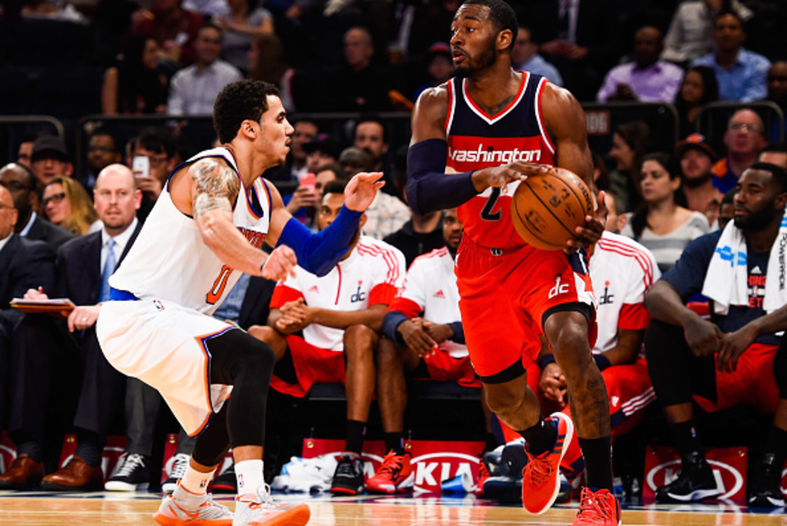 NEW YORK, NY - OCTOBER 22: John Wall #2 of the Washington Wizards controls the ball against Shane Larkin #0 of the New York Knicks in a preseason game at Madison Square Garden on October 22, 2014 in New York City. NOTE TO USER: User expressly acknowledges