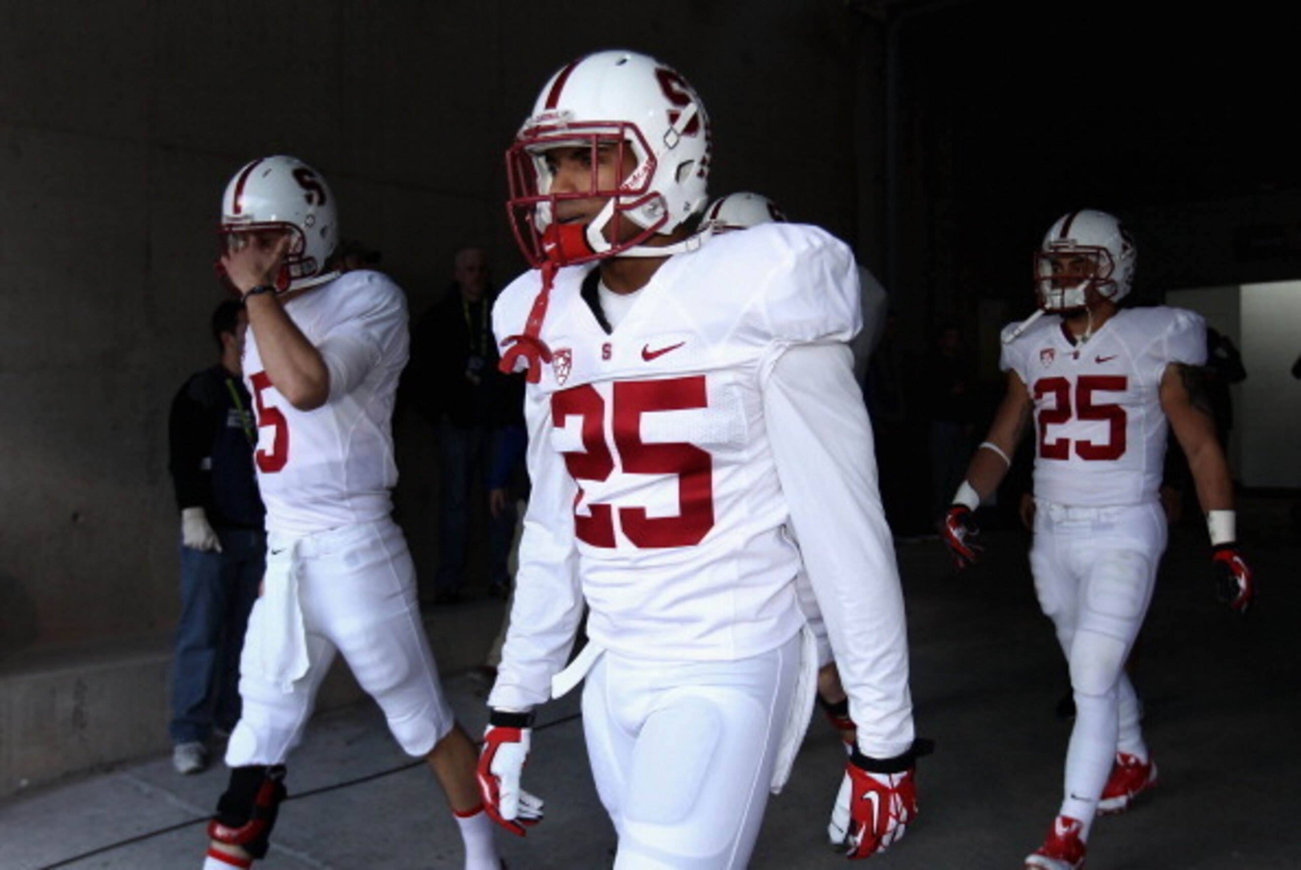 TEMPE, AZ - DECEMBER 07:  Cornerback Alex Carter #25 (C) of the Stanford Cardinal walks out onto the field with teammates before the Pac 12 Championship game against the Arizona State Sun Devils at Sun Devil Stadium on December 7, 2013 in Tempe, Arizona. 