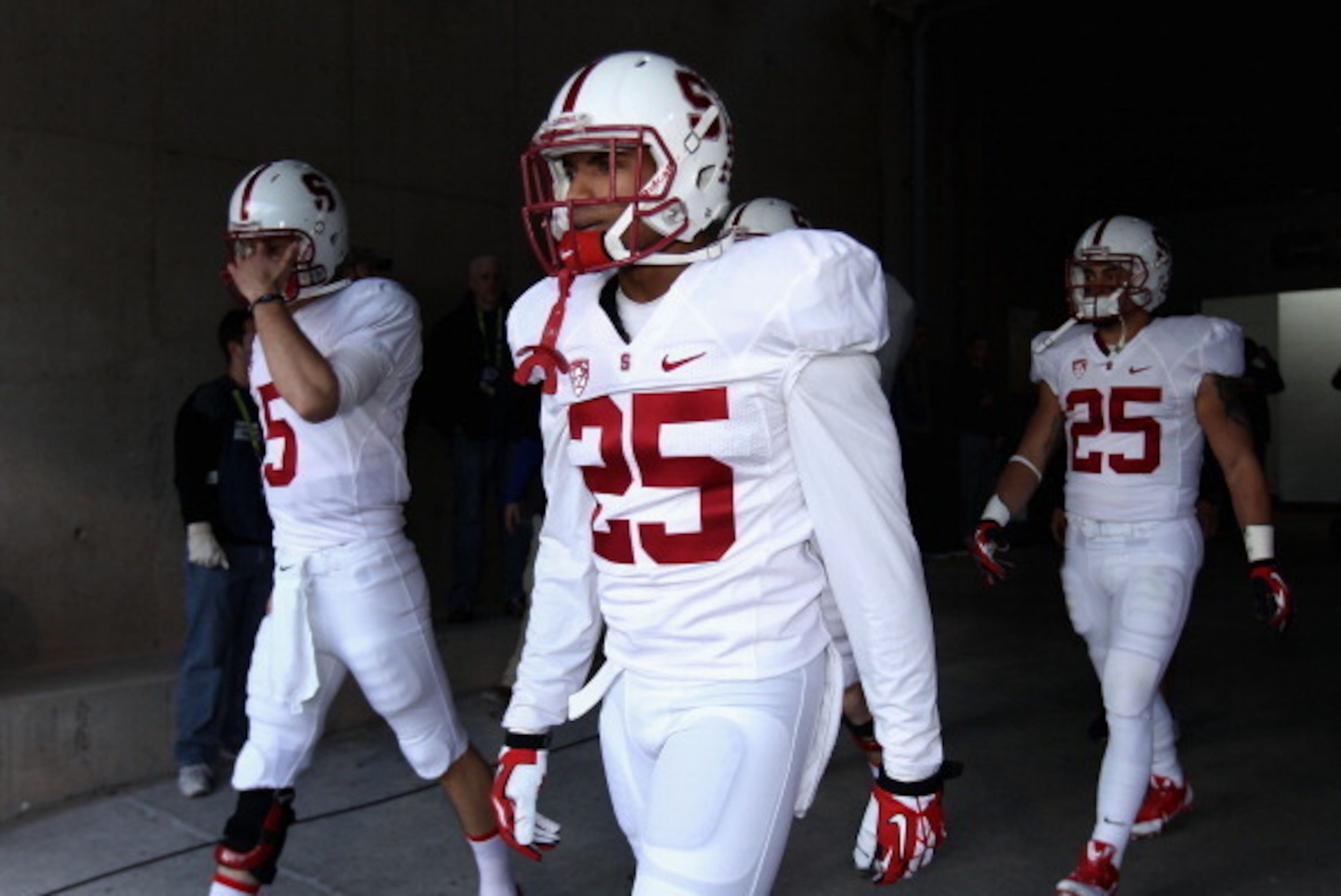TEMPE, AZ - DECEMBER 07:  Cornerback Alex Carter #25 (C) of the Stanford Cardinal walks out onto the field with teammates before the Pac 12 Championship game against the Arizona State Sun Devils at Sun Devil Stadium on December 7, 2013 in Tempe, Arizona. 