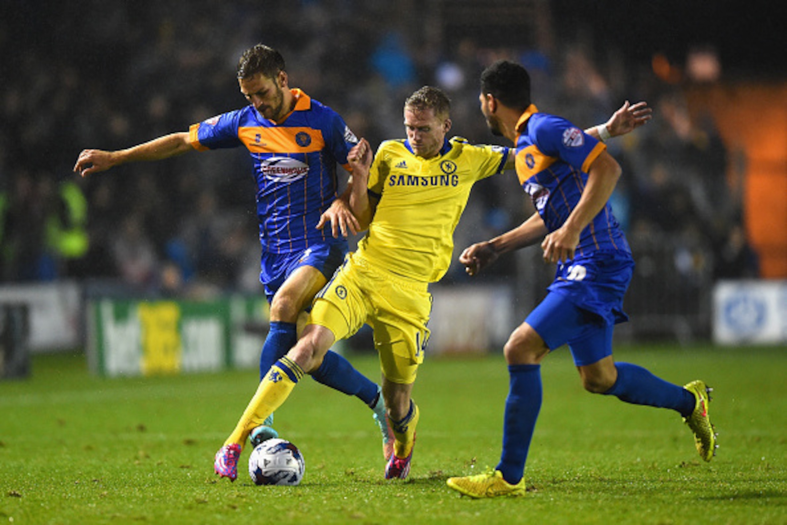SHREWSBURY, ENGLAND - OCTOBER 28: Andre Schurrle of Chelsea battles for the ball with Mickey Demetriou of Shrewsbury Town during the Capital One Cup Fourth Round match between Shrewsbury Town and Chelsea at Greenhous Meadow on October 28, 2014 in Shrewsb SHREWSBURY, ENGLAND - OCTOBER 28: Andre Schurrle of Chelsea battles for the ball with Mickey Demetriou of Shrewsbury Town during the Capital One Cup Fourth Round match between Shrewsbury Town and Chelsea at Greenhous Meadow on October 28, 2014 in Shrewsb