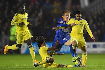 SHREWSBURY, ENGLAND - OCTOBER 28:  Nathan Ake (L) and Mohamed Salah of Chelsea close down Ryan Woods of Shrewsbury Town during the Capital One Cup Fourth Round match between Shrewsbury Town and Chelsea at Greenhous Meadow on October 28, 2014 in Shrewsbury