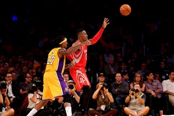 LOS ANGELES, CA - OCTOBER 28:  Dwight Howard #12 of the Houston Rockets catches a pass in front of Jordan Hill #27 of the Los Angeles Lakers at Staples Center on October 28, 2014 in Los Angeles, California.  NOTE TO USER: User expressly acknowledges and a