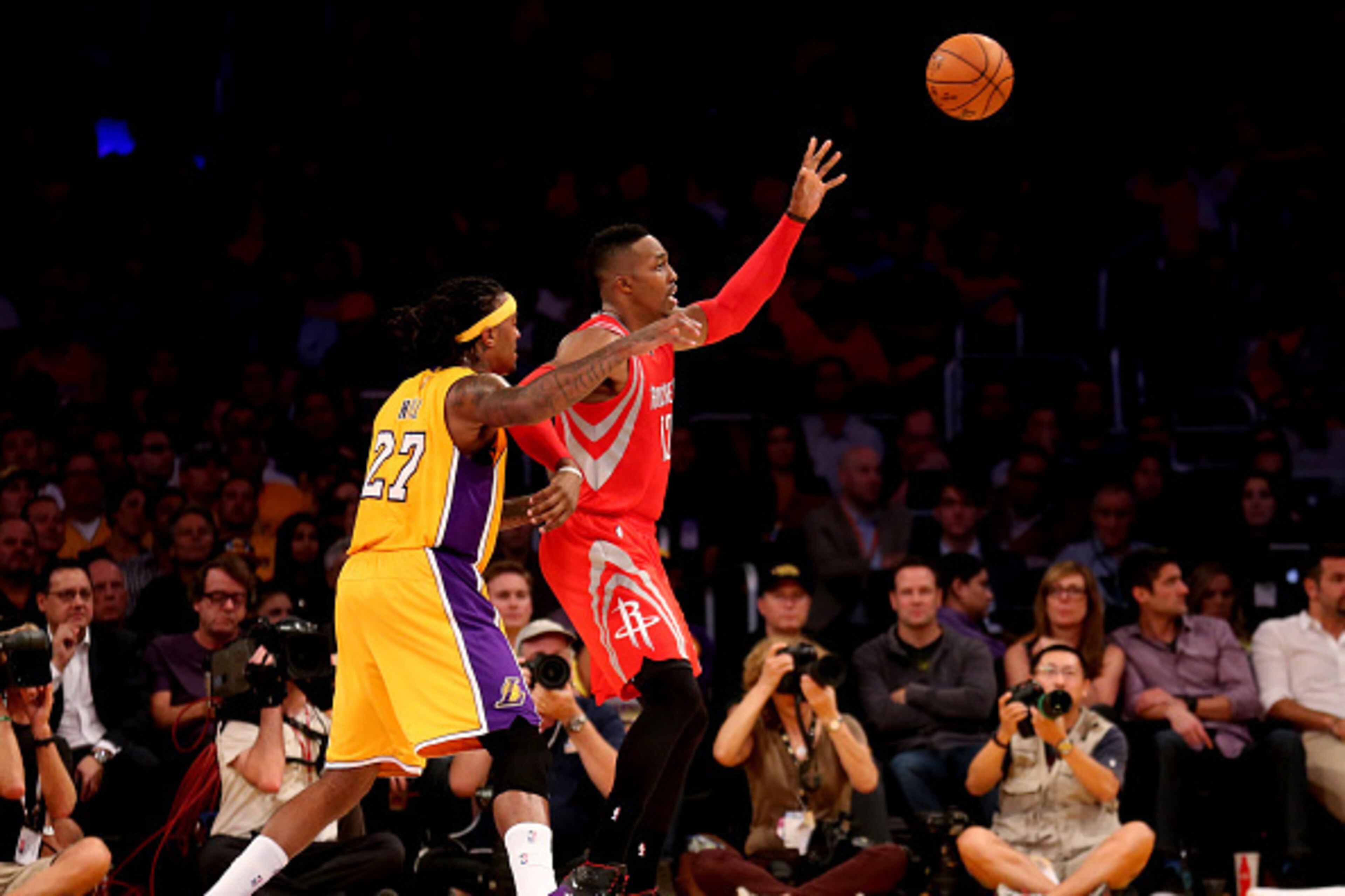 LOS ANGELES, CA - OCTOBER 28:  Dwight Howard #12 of the Houston Rockets catches a pass in front of Jordan Hill #27 of the Los Angeles Lakers at Staples Center on October 28, 2014 in Los Angeles, California.  NOTE TO USER: User expressly acknowledges and a