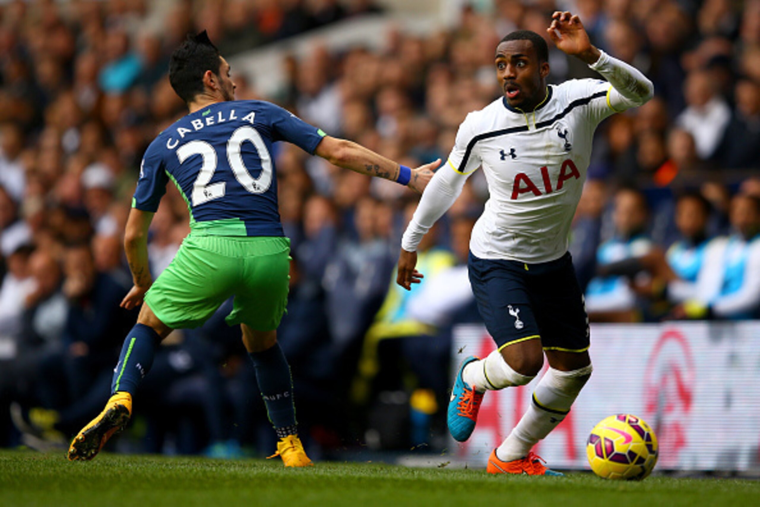 LONDON, ENGLAND - OCTOBER 26:  Danny Rose of Spurs runs with the ball past Remy Cabella of Newcastle United during the Barclays Premier League match between Tottenham Hotspur and Newcastle United at White Hart Lane on October 26, 2014 in London, England. 