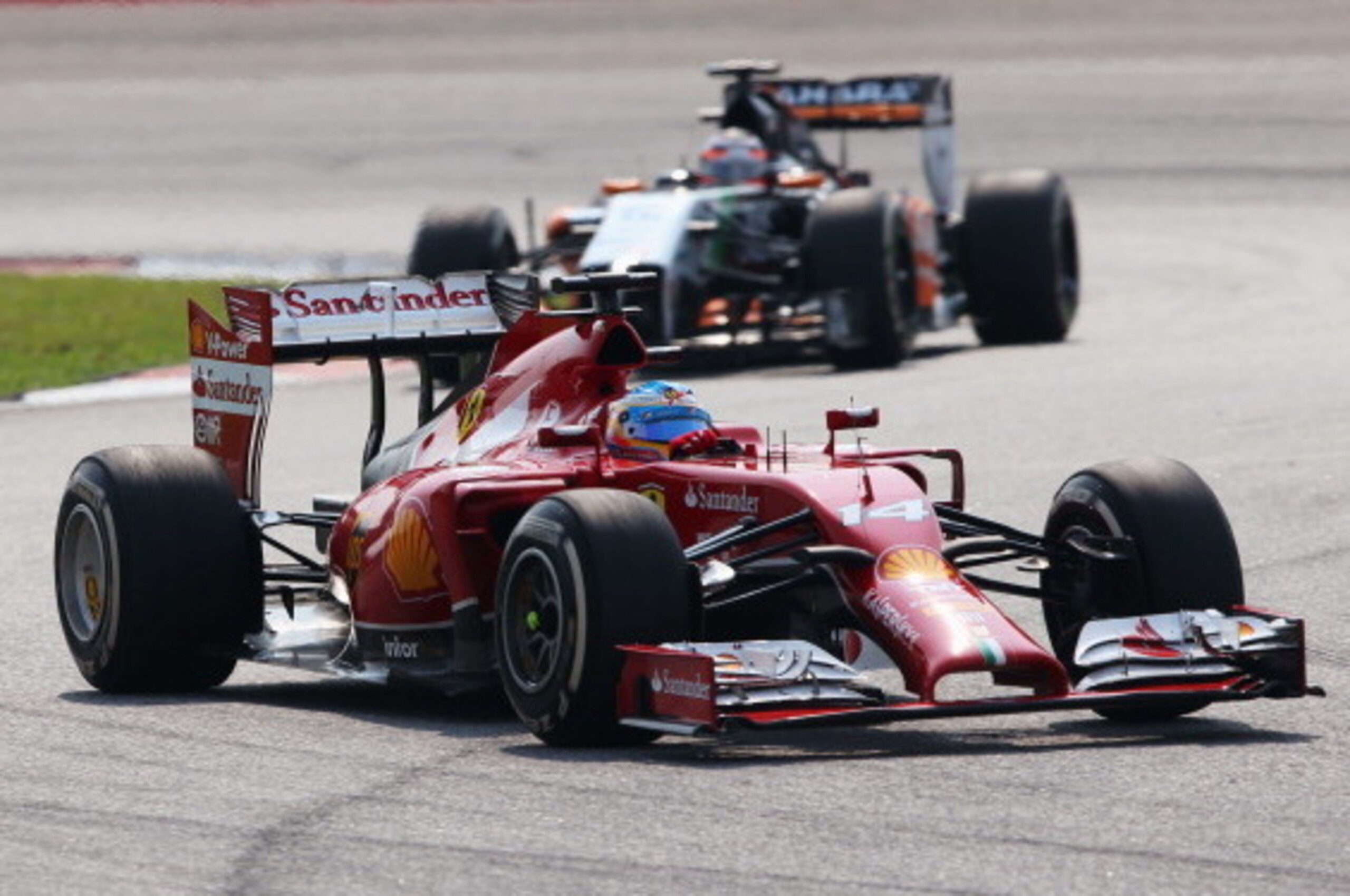 KUALA LUMPUR, MALAYSIA - MARCH 30:  Fernando Alonso of Spain and Ferrari and Nico Hulkenberg of Germany and Force India race during the Malaysia Formula One Grand Prix at the Sepang Circuit on March 30, 2014 in Kuala Lumpur, Malaysia.  (Photo by Mark Thom