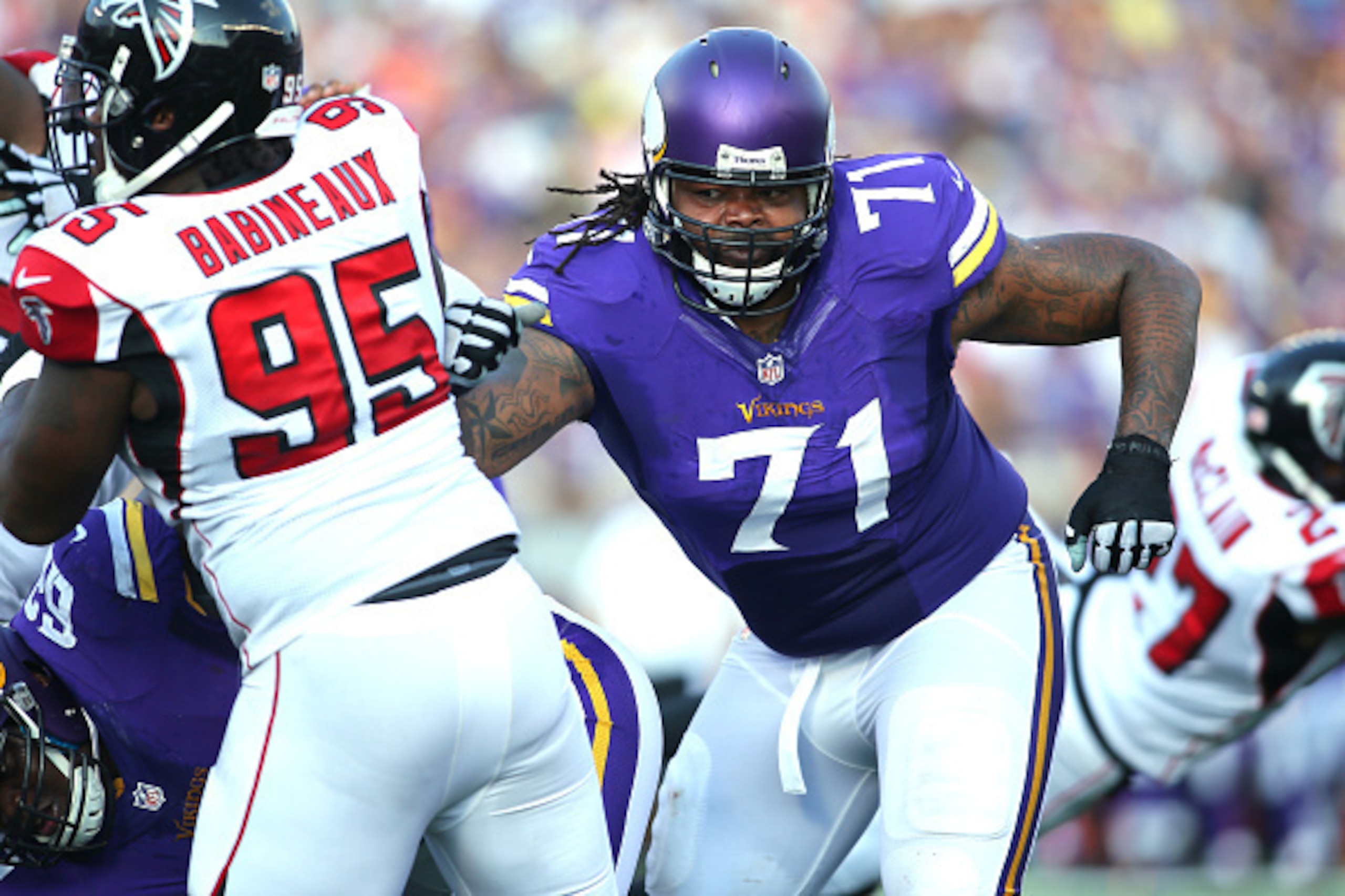 MINNEAPOLIS, MN - SEPTEMBER 28:  Phil Loadholt #71 of the Minnesota Vikings applies pressure on Jonathan Babineaux #95 of the Atlanta Falcons on September 28, 2014 at TCF Bank Stadium in Minneapolis, Minnesota. (Photo by Adam Bettcher/Getty Images)