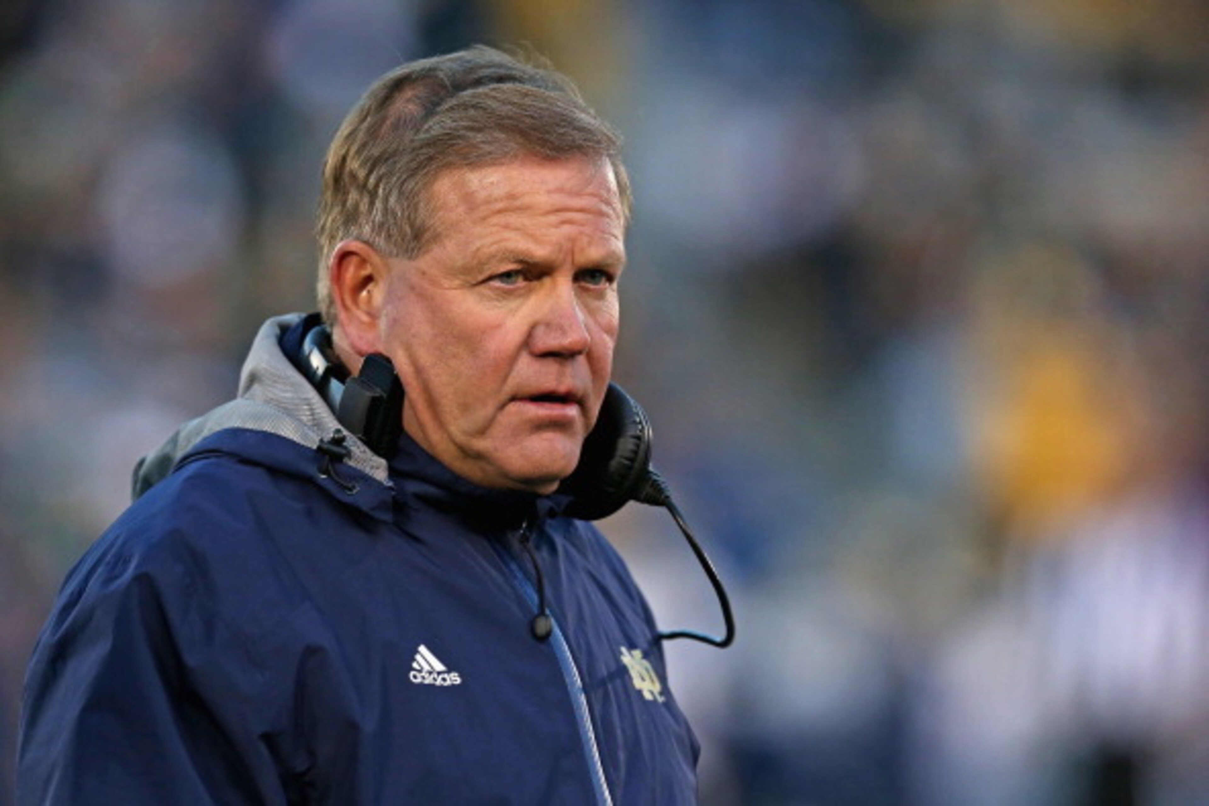 SOUTH BEND, IN - NOVEMBER 02:  Head coach Brian Kelly of the Notre Dame Fighting Irish walks off of the field after checking on an injured player during a game against the Navy Midshipmen at Notre Dame Stadium on November 2, 2013 in South Bend, Indiana. N