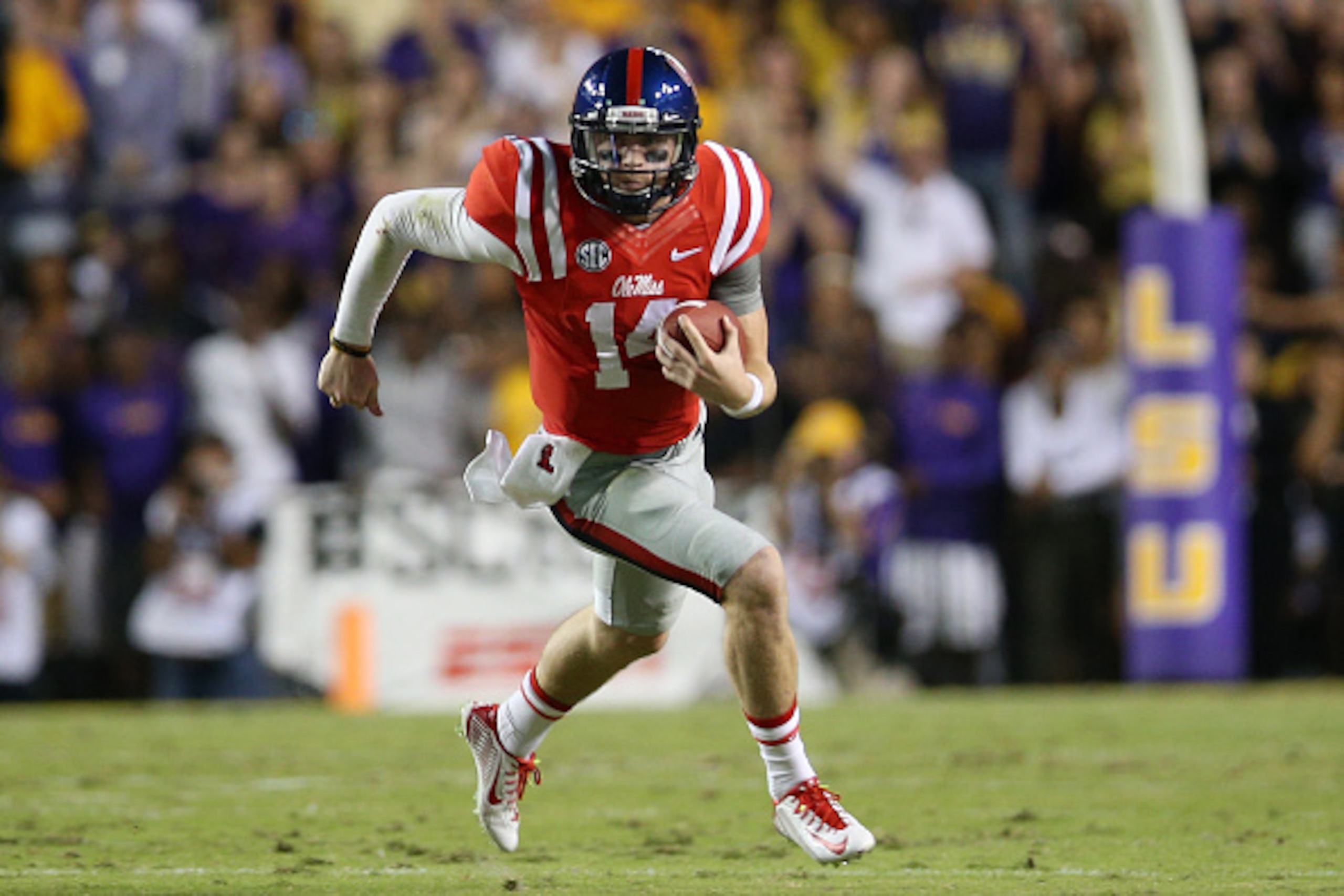 BATON ROUGE, LA - OCTOBER 25:  Quarterback Bo Wallace #14 of the Mississippi Rebels runs the ball against the LSU Tigers at Tiger Stadium on October 25, 2014 in Baton Rouge, Louisiana.  (Photo by Chris Graythen/Getty Images)