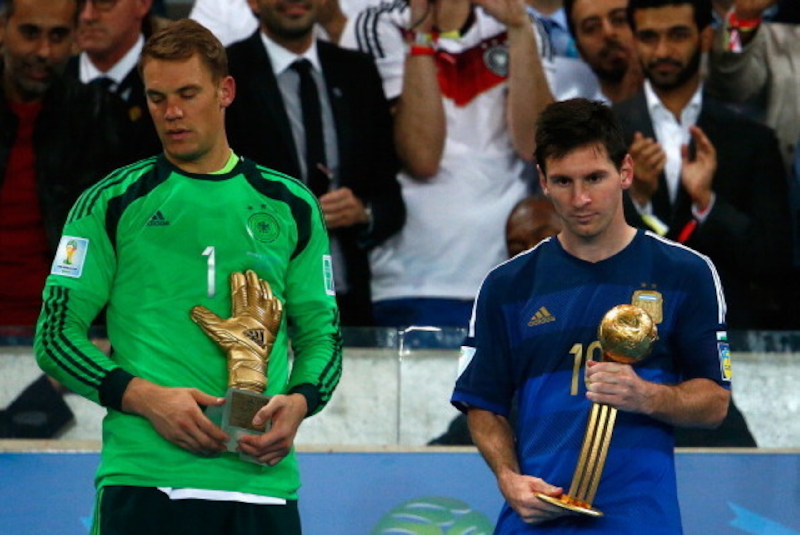 RIO DE JANEIRO, BRAZIL - JULY 13: Manuel Neuer of Germany holds the Golden Glove trophy as Lionel Messi of Argentina holds the Golden Ball trophy during the 2014 FIFA World Cup Brazil Final match between Germany and Argentina at Maracana on July 13, 2014 