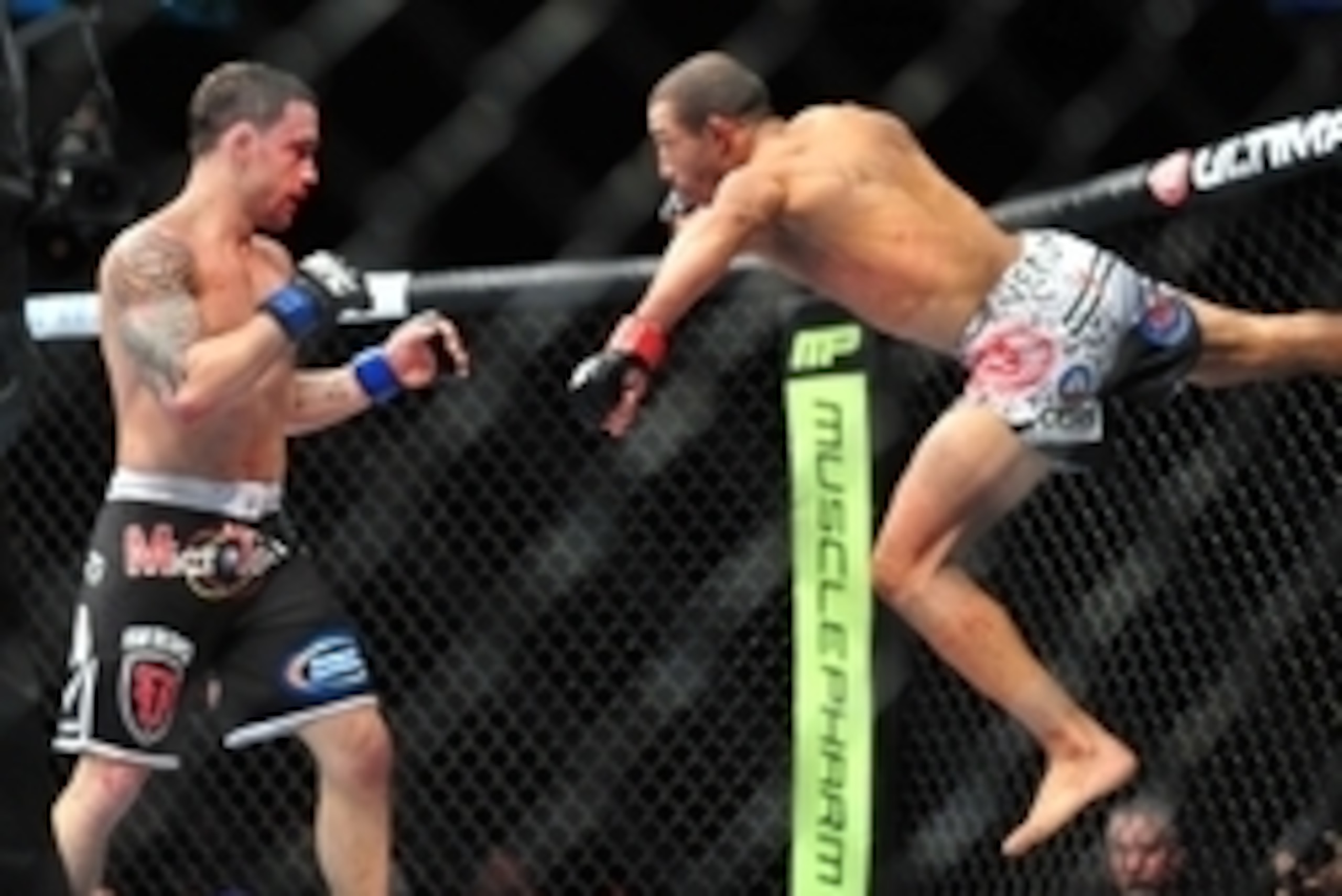 Feb 2, 2013; Las Vegas, NV, USA; Frankie Edgar (left) and Jose Aldo (right) battle each other during UFC 156 at the Mandalay Bay Events Center. Mandatory Credit: Gary A. Vasquez-USA TODAY Sports