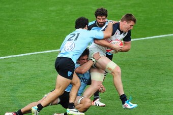 KENNESAW, GA - MARCH 29: Cameron Dolan #8 of the USA Eagles carries the ball against Juan De Freitas #21,  Santiago Vilaseca #4, and Jeronimo Etcheverry #11 of Uruguay during the opening qualifying match of the 2015 IRB Rugby World Cup between Uruguay and