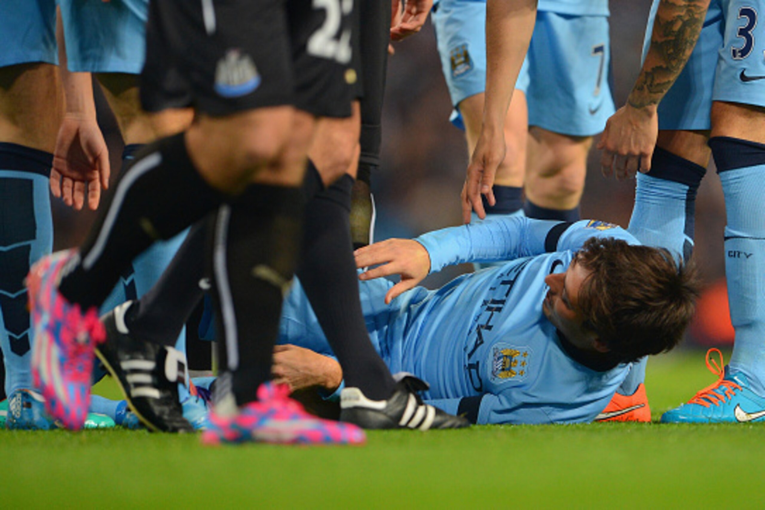 MANCHESTER, ENGLAND - OCTOBER 29:   David Silva of Manchester City after he lies injured after a tackle from Ryan Taylor of Newcastle United during the Capital One Cup Fourth Round match between Manchester City and Newcastle United at Etihad Stadium on Oc