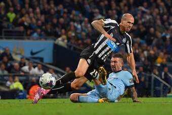 MANCHESTER, ENGLAND - OCTOBER 29: Aleksandar Kolarov of Manchester City tackles Gabriel Obertan of Newcastle United in the area during the Capital One Cup Fourth Round match between Manchester City and Newcastle United at Etihad Stadium on October 29, 201