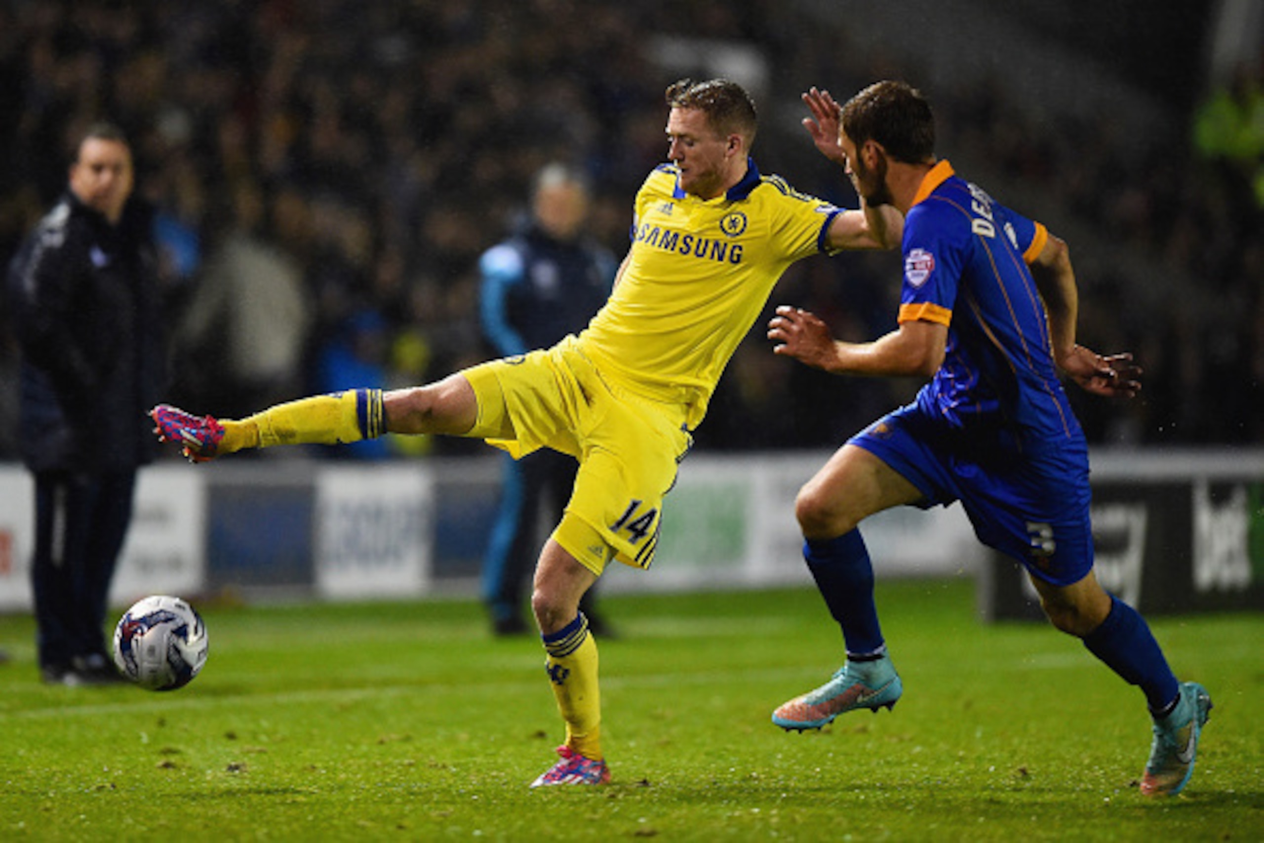 SHREWSBURY, ENGLAND - OCTOBER 28:  Andre Schurrle of Chelsea is challenged by Mickey Demetriou of Shrewsbury Town during the Capital One Cup Fourth Round match between Shrewsbury Town and Chelsea at Greenhous Meadow on October 28, 2014 in Shrewsbury, Engl