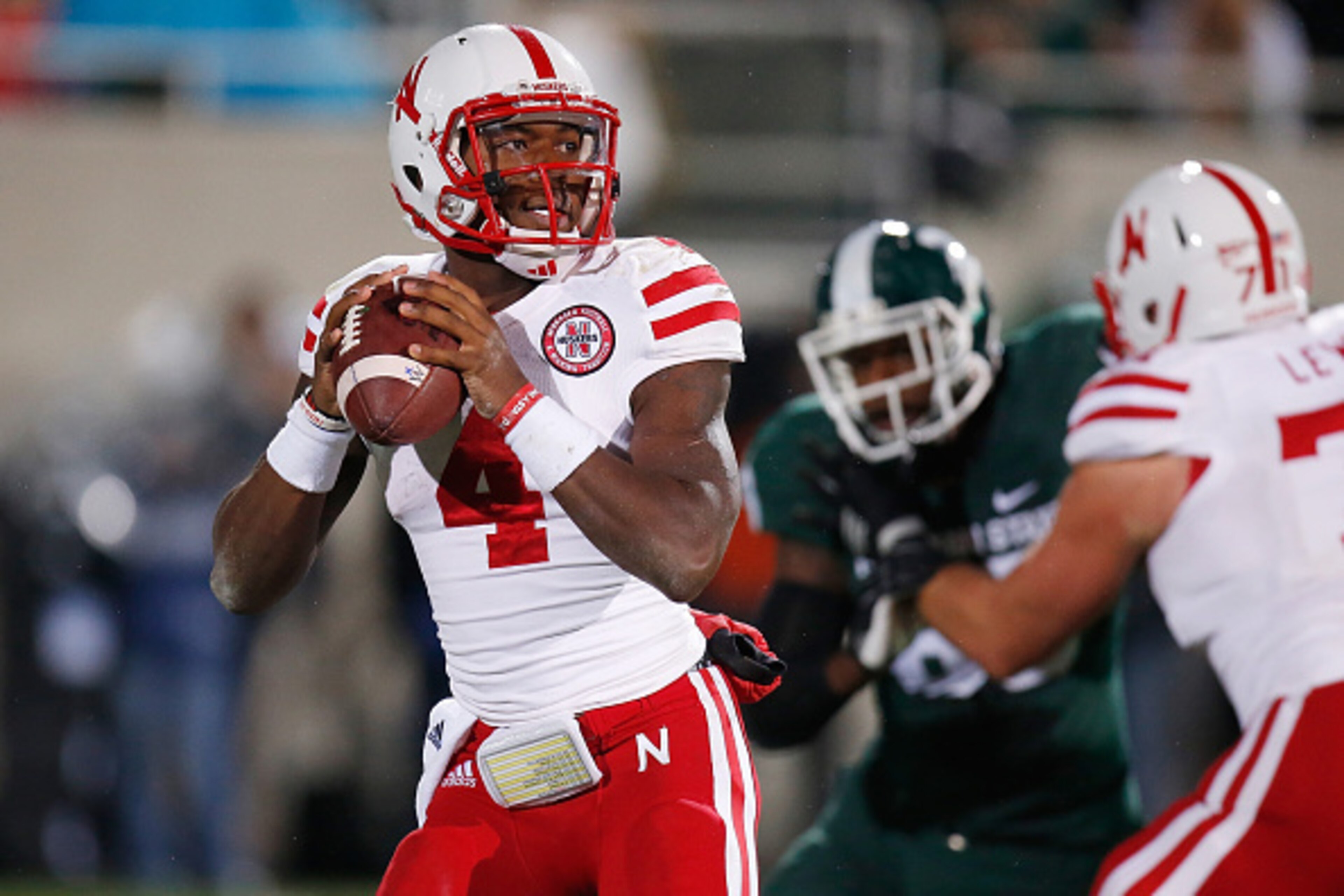 EAST LANSING, MI - OCTOBER 04: Tommy Armstrong Jr. #4 of the Nebraska Cornhuskers looks to pass in the second quarter against the Michigan State Spartans at Spartan Stadium on October 4, 2014 in East Lansing, Michigan. (Photo by Gregory Shamus/Getty Image