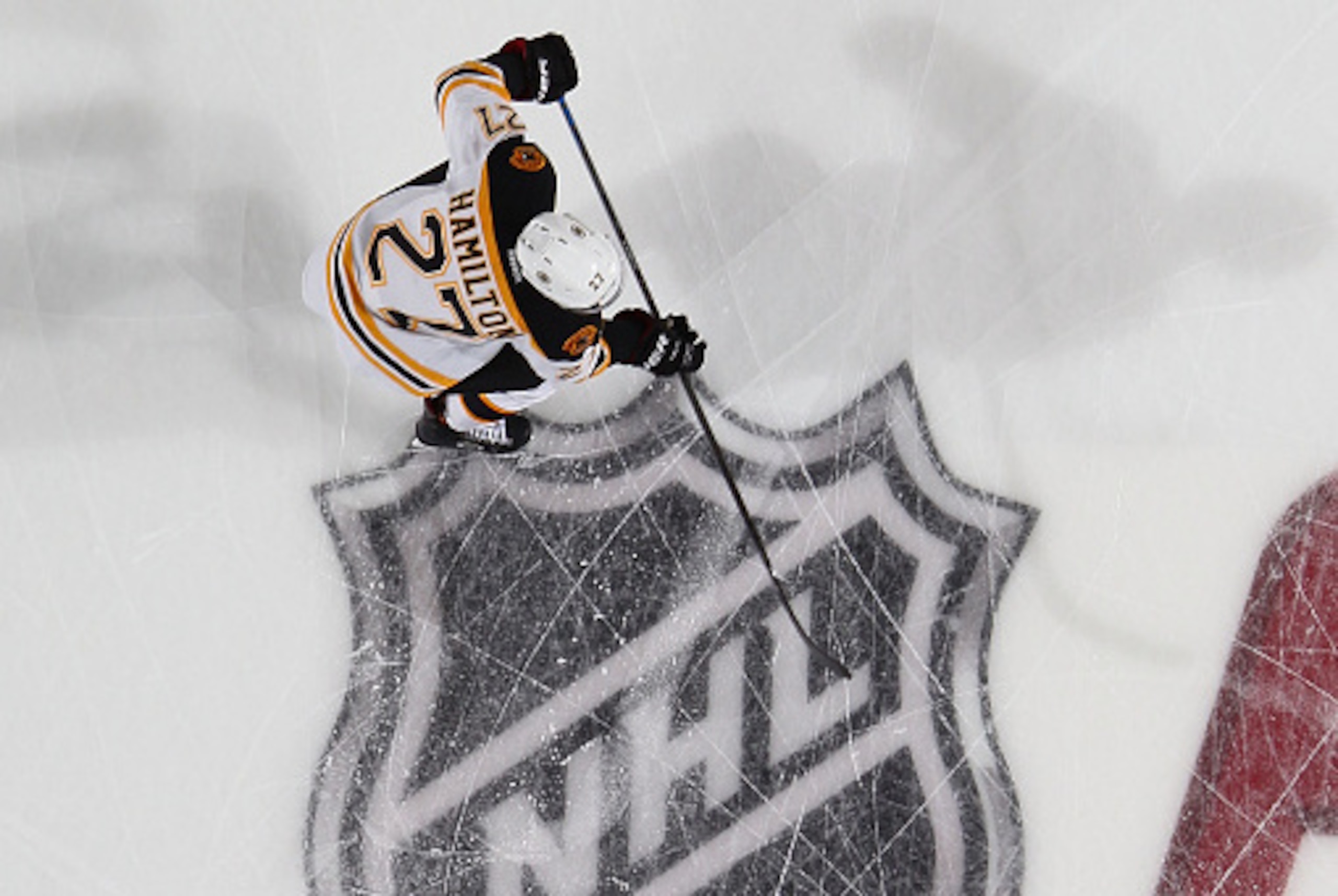 BUFFALO, NY - OCTOBER 18:  Dougie Hamilton #27 of the Boston Bruins skates through the NHL ice logo during a game between the Buffalo Sabres and the Boston Bruins on October 18, 2014 at the First Niagara Center in Buffalo, New York.  (Photo by Bill Wipper