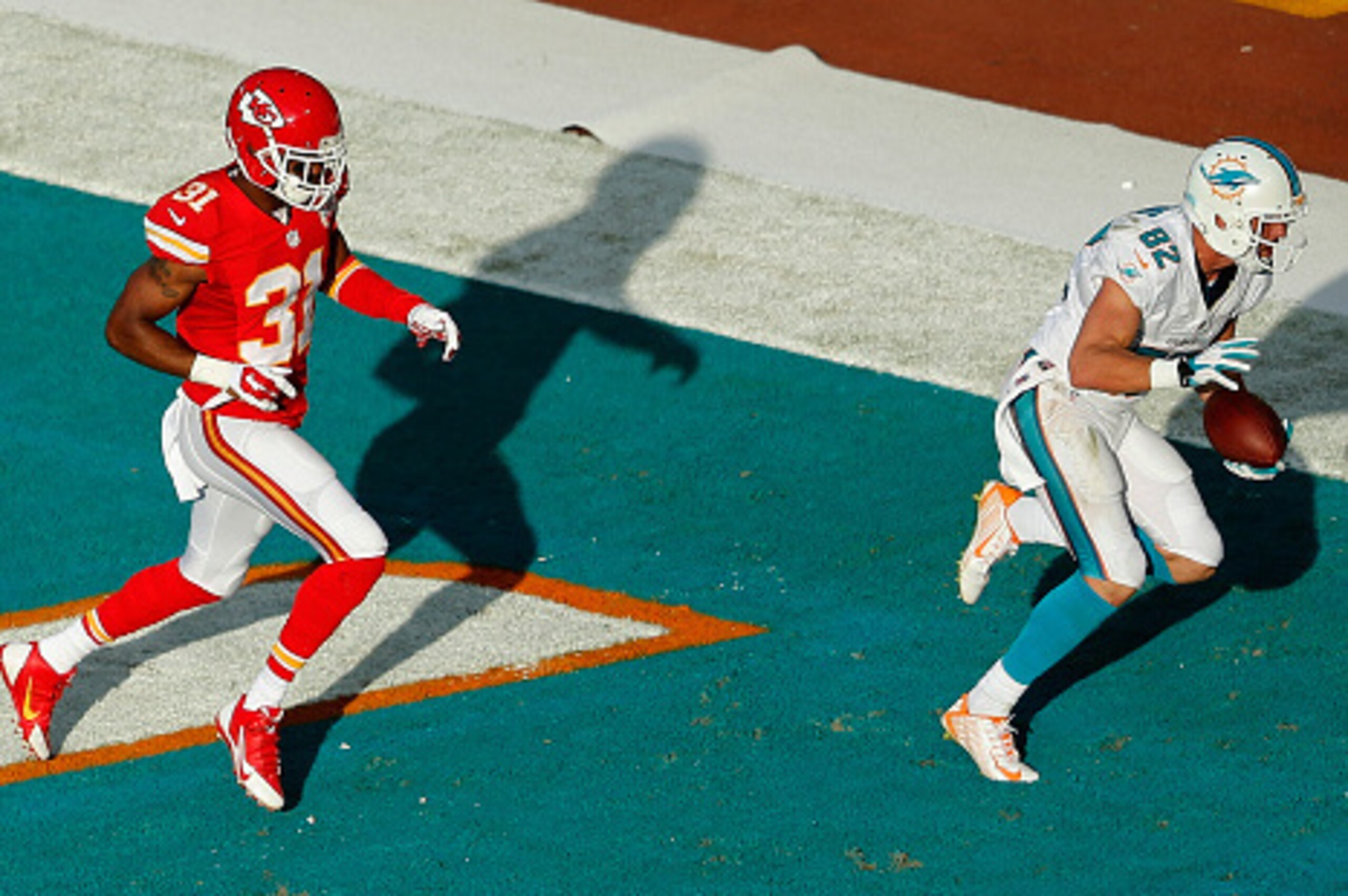 MIAMI GARDENS, FL - SEPTEMBER 21:  Wide receiver Brian Hartline #82 of the Miami Dolphins catches a third-quarter touchdown pass as cornerback Marcus Cooper #31 of the Kansas City Chiefs trails during a game at Sun Life Stadium on September 21, 2014 in Mi