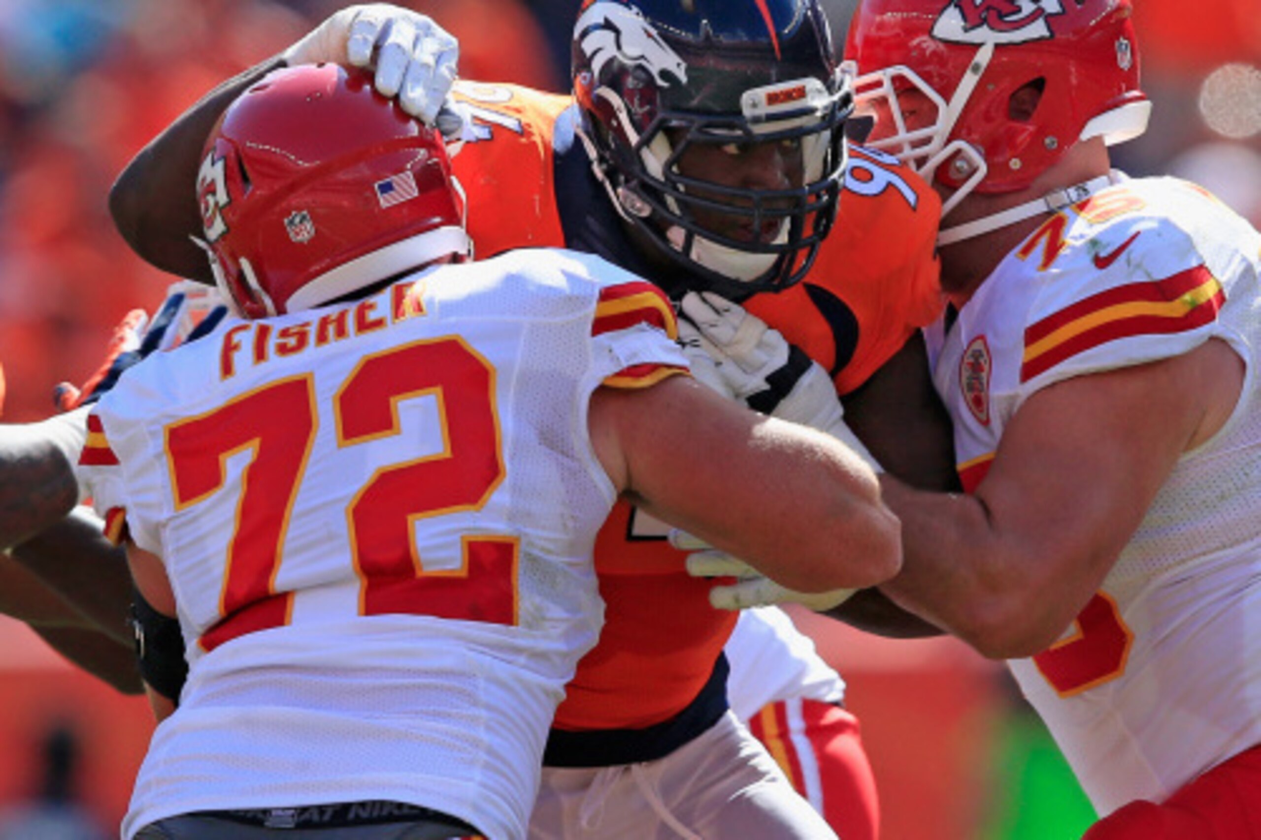 DENVER, CO - SEPTEMBER 14:  Defensive end DeMarcus Ware #94 of the Denver Broncos battles against the block of offensive guard offensive tackle Eric Fisher #72 and guard Mike McGlynn #75 of the Kansas City Chiefs at Sports Authority Field at Mile High on 