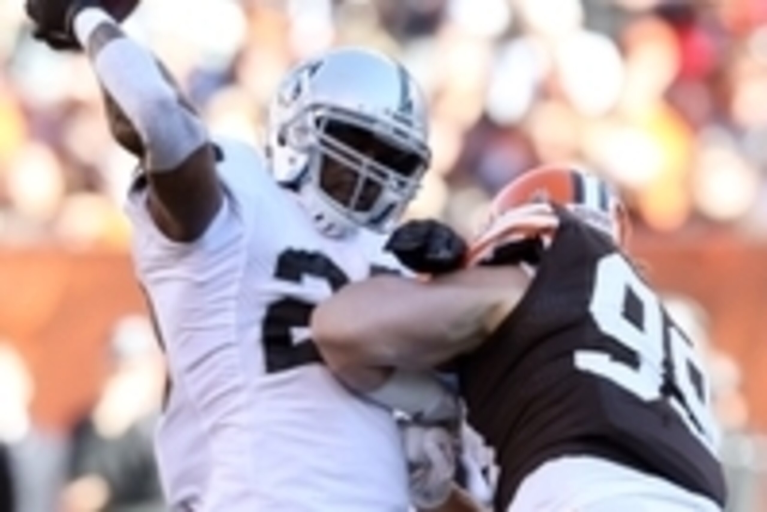 Oct 26, 2014; Cleveland, OH, USA; Oakland Raiders running back Darren McFadden (20) throws a pass as he is hit by Cleveland Browns outside linebacker Paul Kruger (99) during the first quarter at FirstEnergy Stadium. Mandatory Credit: Ron Schwane-USA TODAY Oct 26, 2014; Cleveland, OH, USA; Oakland Raiders running back Darren McFadden (20) throws a pass as he is hit by Cleveland Browns outside linebacker Paul Kruger (99) during the first quarter at FirstEnergy Stadium. Mandatory Credit: Ron Schwane-USA TODAY