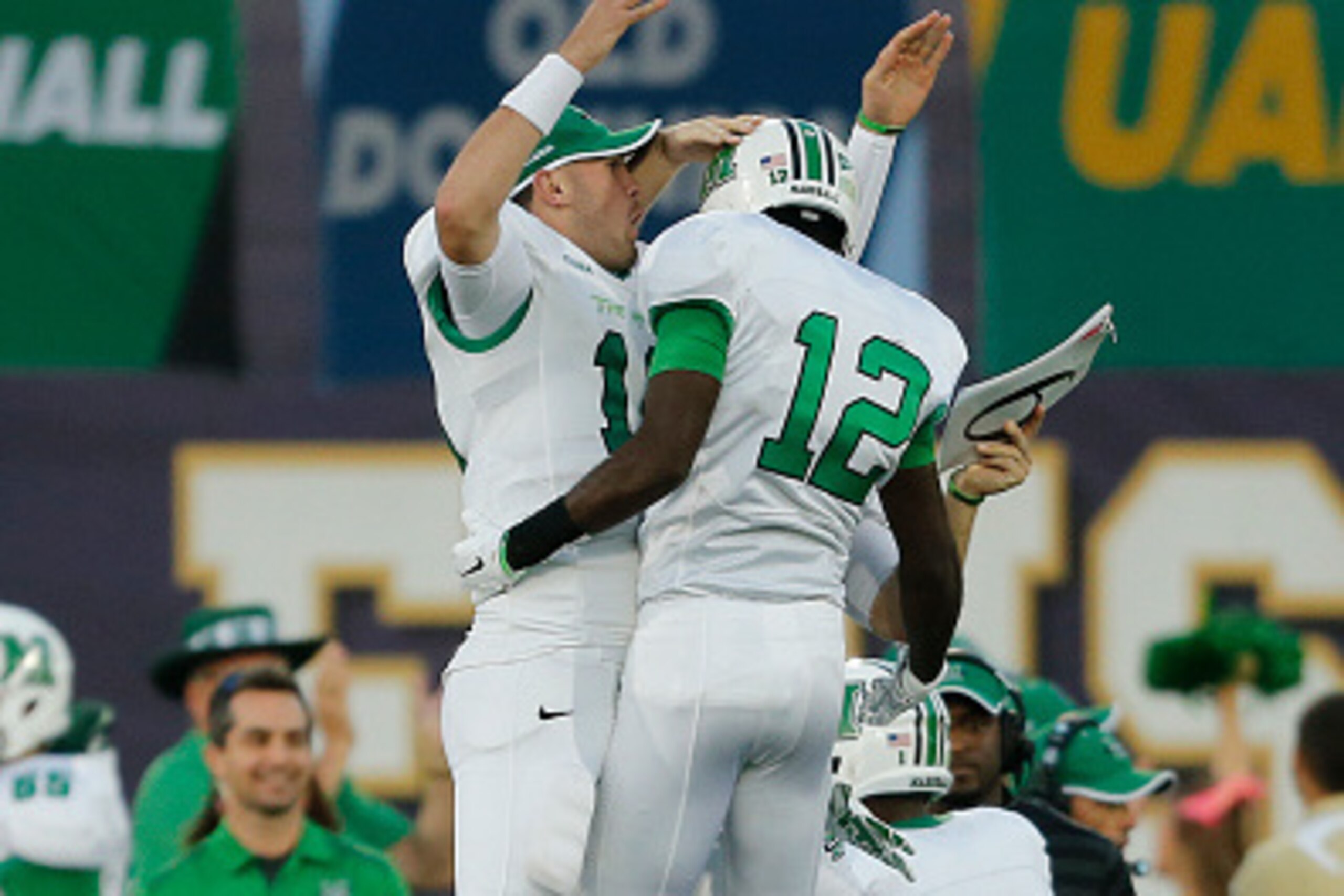 MIAMI, FL - OCTOBER 18: Rakeem Cato #12 celebrates his first half touchdown pass with Gunnar Holcombe #10 of the Marshall Thundering Herd against the Florida International Panthers on October 18, 2014 at FIU Stadium in Miami, Florida.(Photo by Joel Auerba