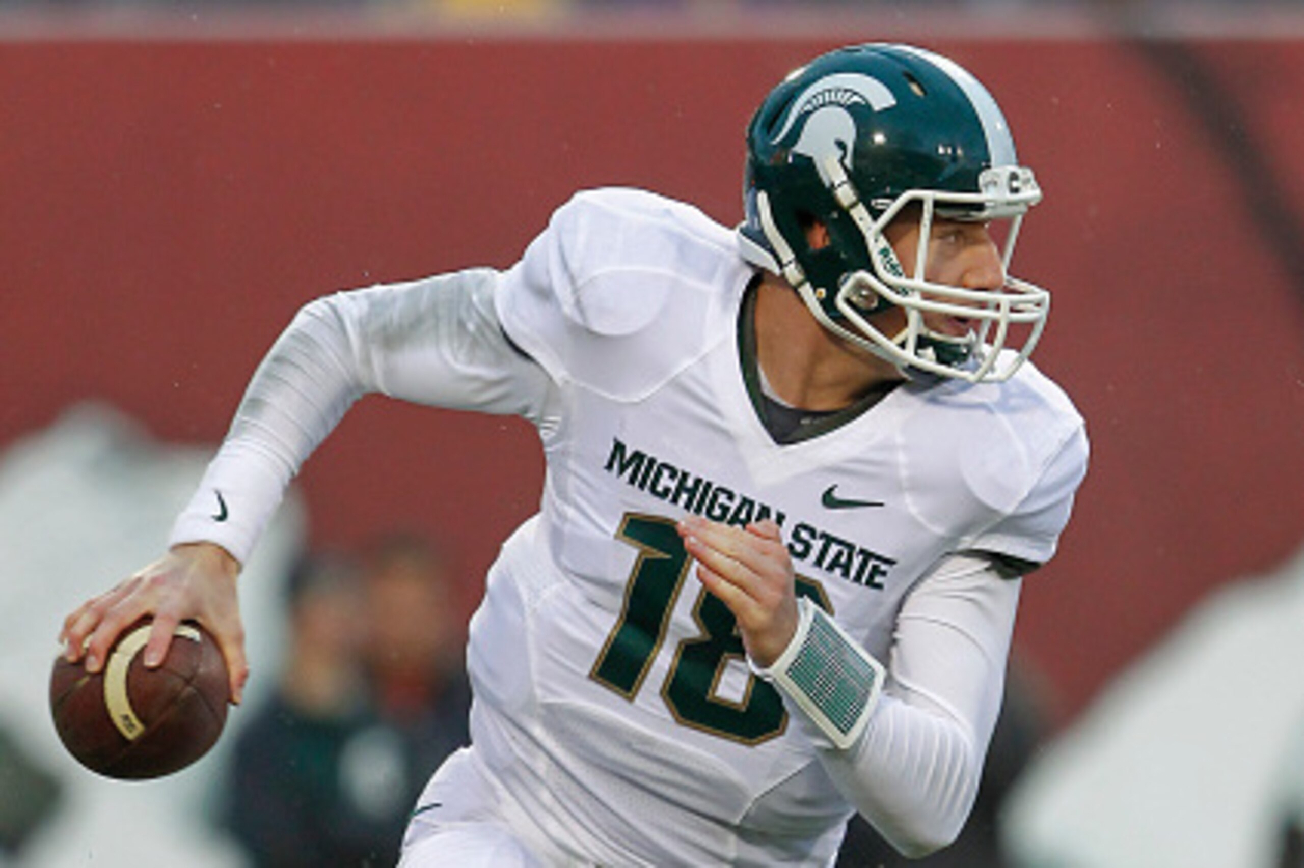 BLOOMINGTON, IN - OCTOBER 18: Connor Cook #18 of the Michigan State Spartans scrambles out of the pocket during the game against the Indiana Hoosiers at Memorial Stadium on October 18, 2014 in Bloomington, Indiana. Michigan State defeated Indiana 56-17. (