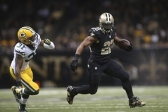Oct 26, 2014; New Orleans, LA, USA; New Orleans Saints running back Mark Ingram (22) carries the ball past Green Bay Packers cornerback Davon House (31) in the second half at Mercedes-Benz Superdome. New Orleans defeated Green Bay 44-23. Mandatory Credit: