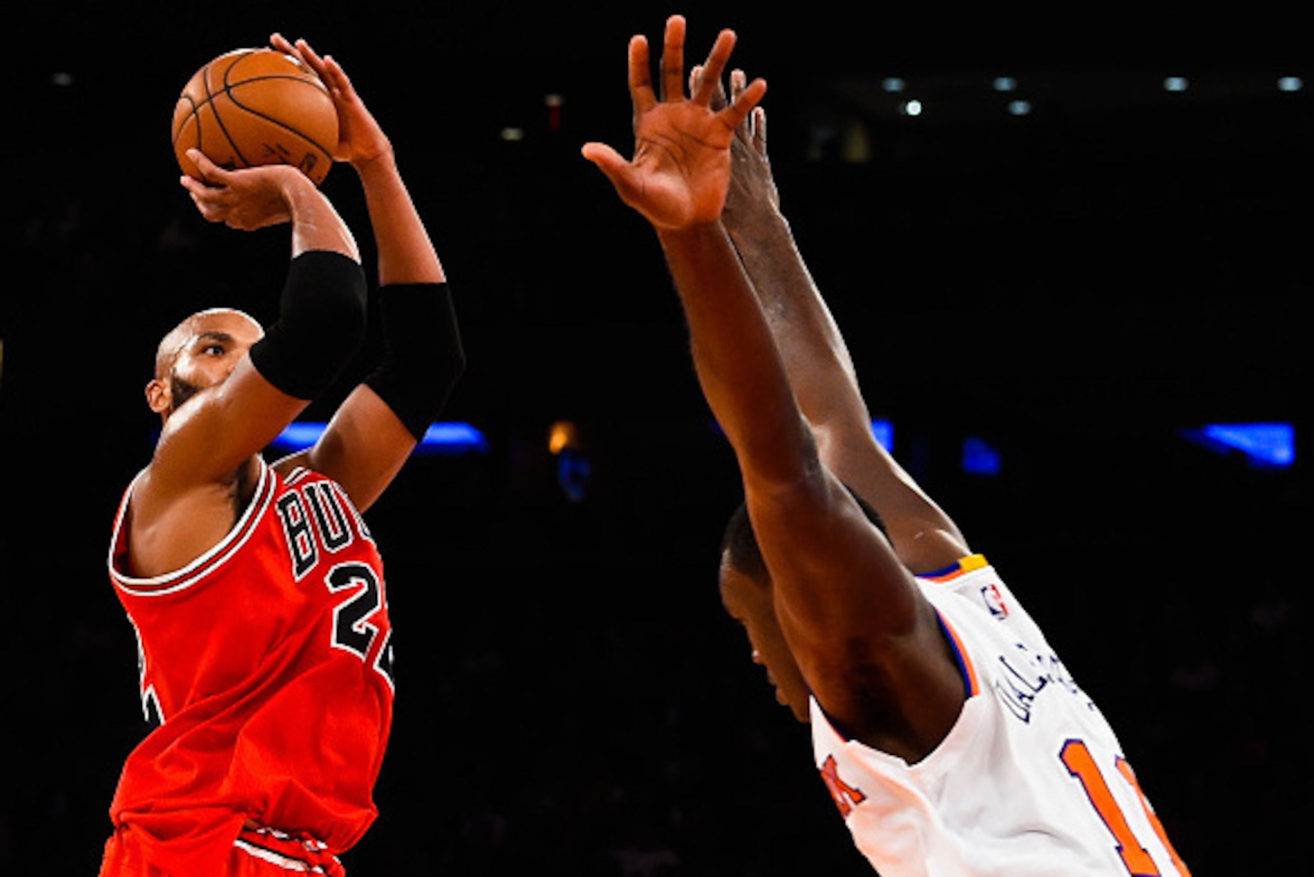 NEW YORK, NY - OCTOBER 29: Taj Gibson #22 of the Chicago Bulls shoots over Samuel Dalembert #11 of the New York Knicks in the second quarter during a game at Madison Square Garden on October 29, 2014 in New York City. NOTE TO USER: User expressly acknowle