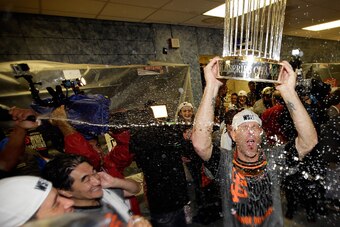 KANSAS CITY, MO - OCTOBER 29:  Tim Hudson #17 of the San Francisco Giants celebrates with The Commissioner's Trophy after defeating the Kansas City Royals 3-2 Game Seven of the 2014 World Series at Kauffman Stadium on October 29, 2014 in Kansas City, Miss