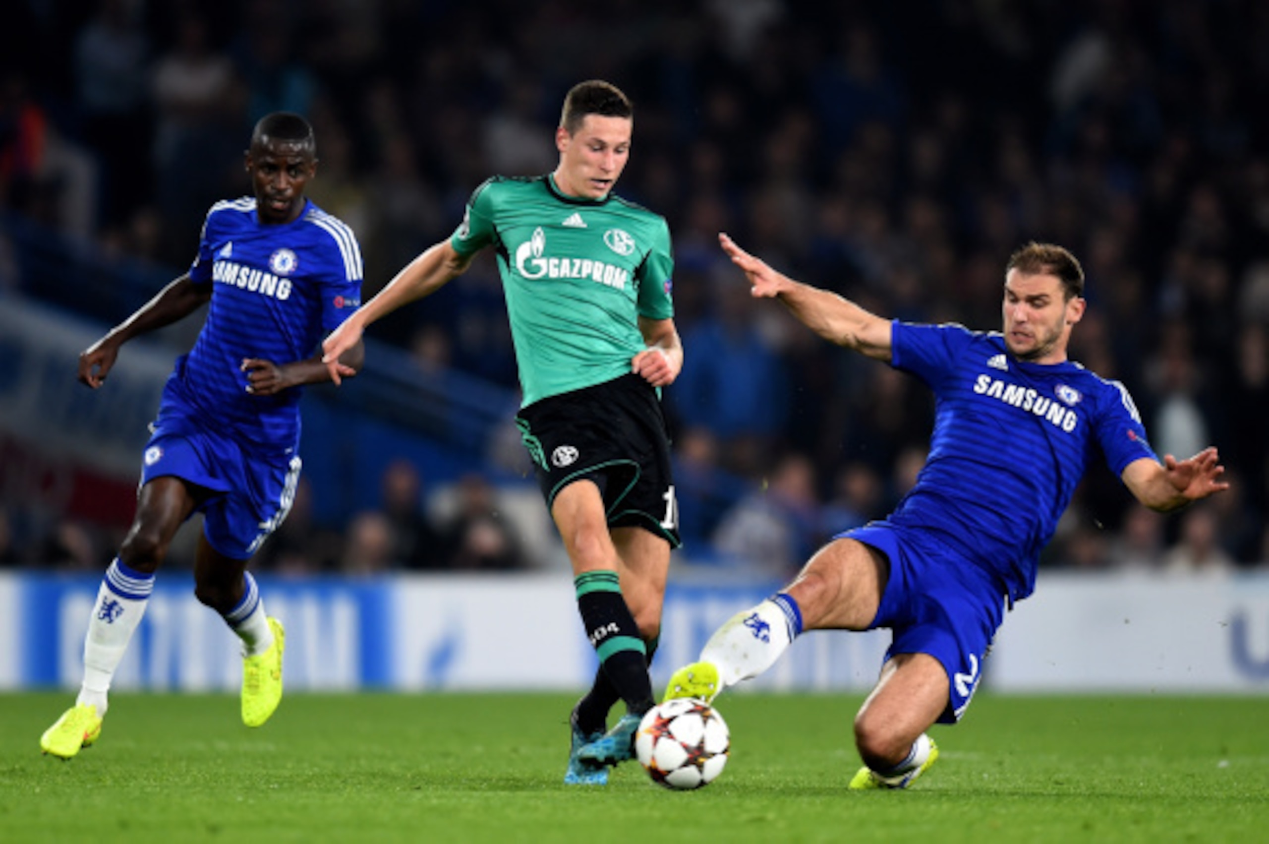LONDON, ENGLAND - SEPTEMBER 17:  Julian Draxler of Schalke is tackled by Branislav Ivanovic of Chelsea  during the UEFA Champions League Group G match between Chelsea and FC Schalke 04 on September 17, 2014 in London, United Kingdom.  (Photo by Mike Hewit