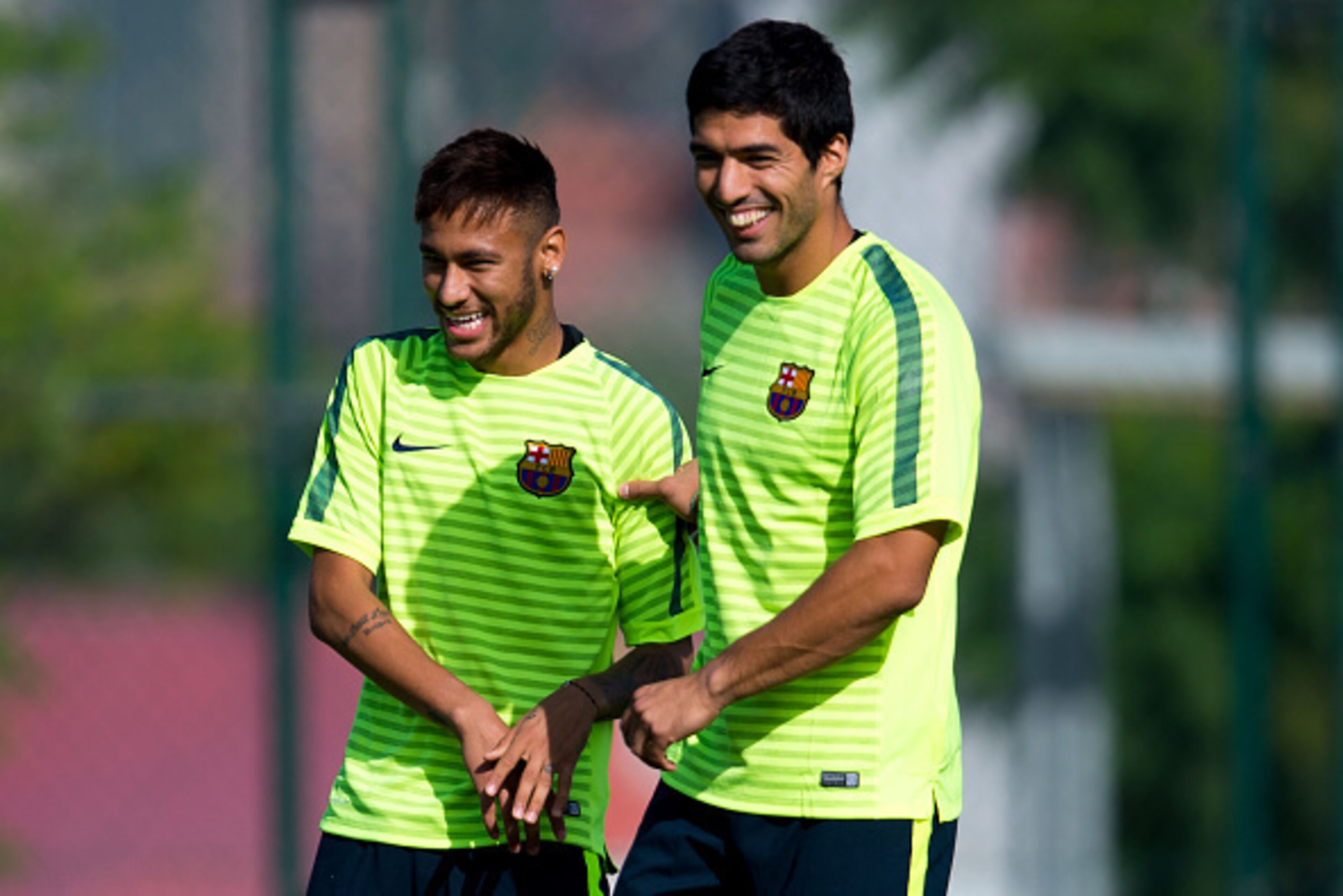 BARCELONA, SPAIN - OCTOBER 20:  Neymar (L) and Luis Suarez of FC Barcelona  share a joke during a training session ahead of their UEFA Champions League Group F match against AFC Ajax at Ciutat Esportiva on October 20, 2014 in Barcelona, Spain.  (Photo by 