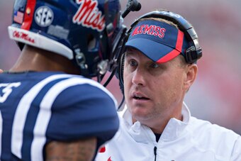 OXFORD, MS - SEPTEMBER 13:  Head Coach Hugh Freeze of the Ole Miss Rebels talks with a player on the sidelines during a game against the Louisiana-Lafayette Ragin' Cajuns at Vaught-Hemingway Stadium on September 13, 2014 in Oxford, Mississippi.  The Rebel