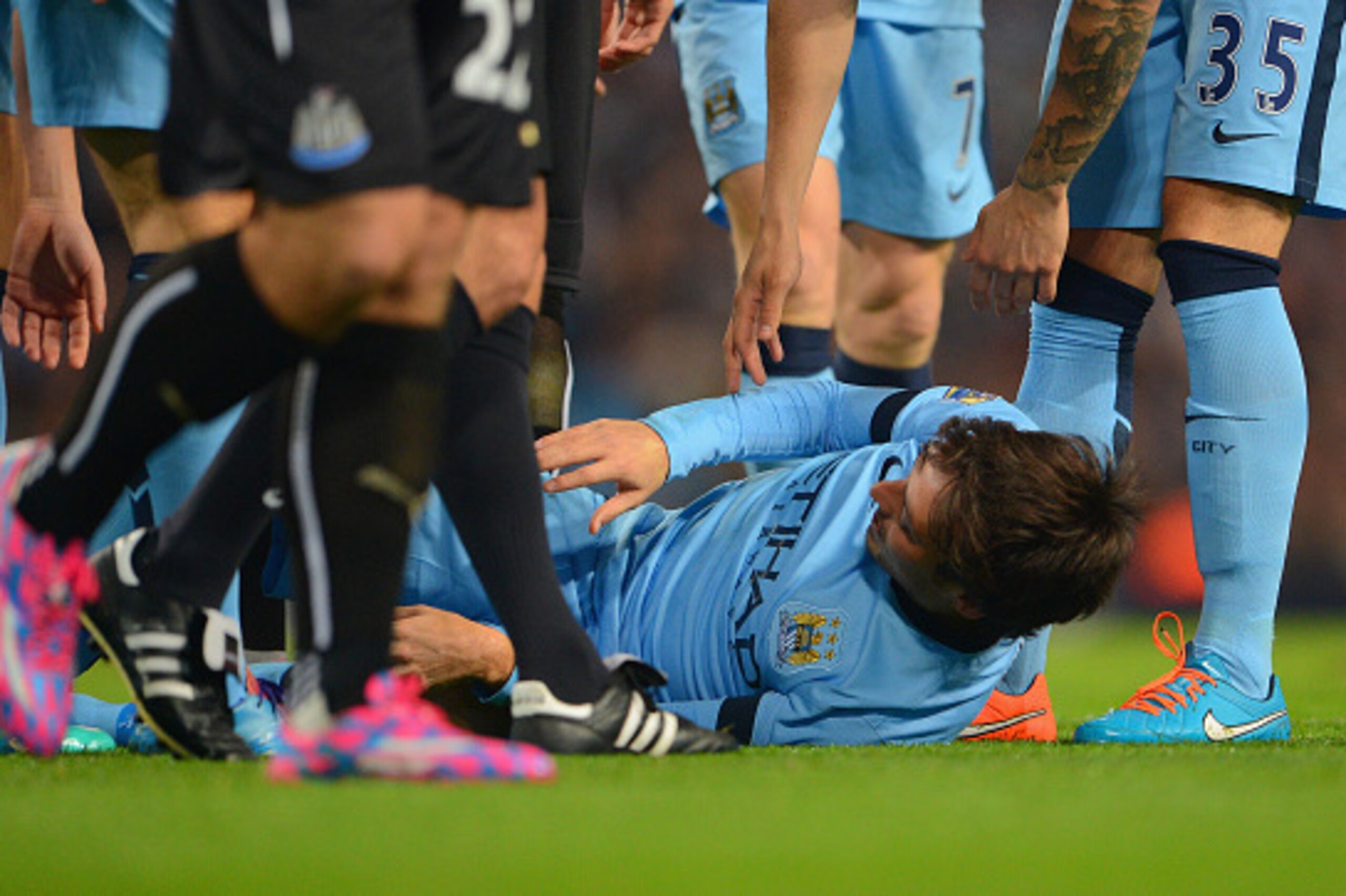 MANCHESTER, ENGLAND - OCTOBER 29:   David Silva of Manchester City after he lies injured after a tackle from Ryan Taylor of Newcastle United during the Capital One Cup Fourth Round match between Manchester City and Newcastle United at Etihad Stadium on Oc