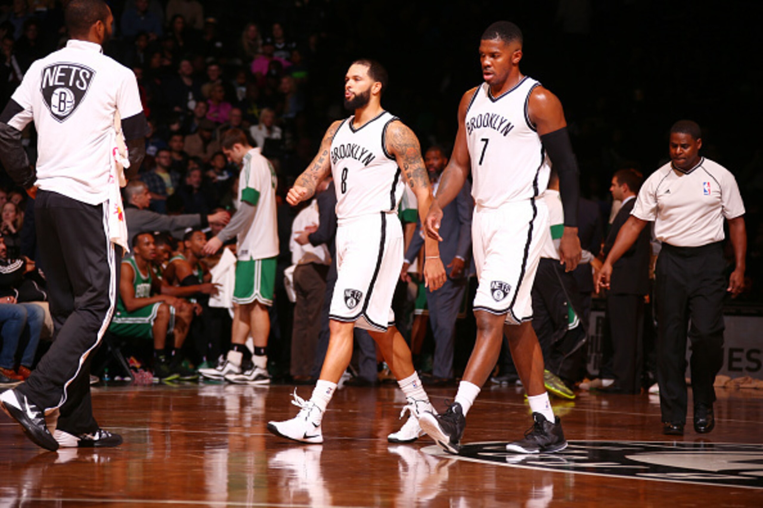 BROOKLYN, NY - OCTOBER 19: Deron Williams #8 and Joe Johnson #7 of the Brooklyn Nets walk toward the bench during the game against the Boston Celtics on October 19, 2014 at Barclays Center in Brooklyn, New York. NOTE TO USER: User expressly acknowledges a