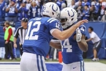 Oct 19, 2014; Indianapolis, IN, USA;  Indianapolis Colts quarterback Andrew Luck (12) congratulates running back Ahmad Bradshaw (44) after scoring a touchdown against the Cincinnati Bengals at Lucas Oil Stadium. Mandatory Credit: Brian Spurlock-USA TODAY 