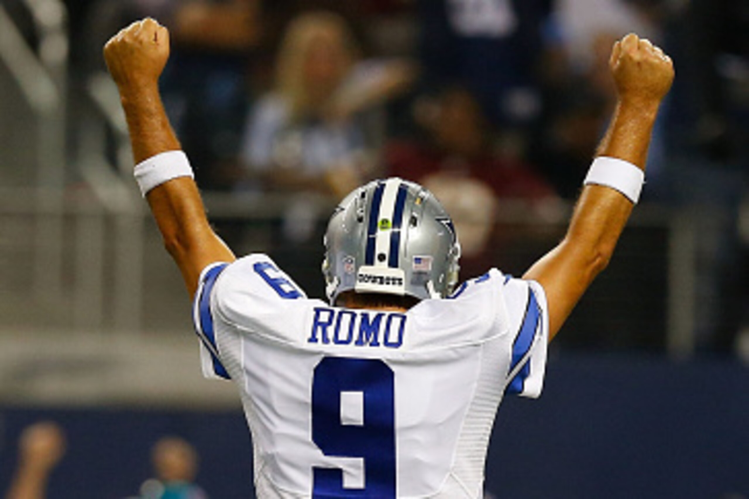 ARLINGTON, TX - OCTOBER 27:  Tony Romo #9 of the Dallas Cowboys reacts after throwing a touchdown pass to Dez Bryant #88 of the Dallas Cowboys against the Washington Redskins during the first half at AT&T Stadium on October 27, 2014 in Arlington, Texas.  