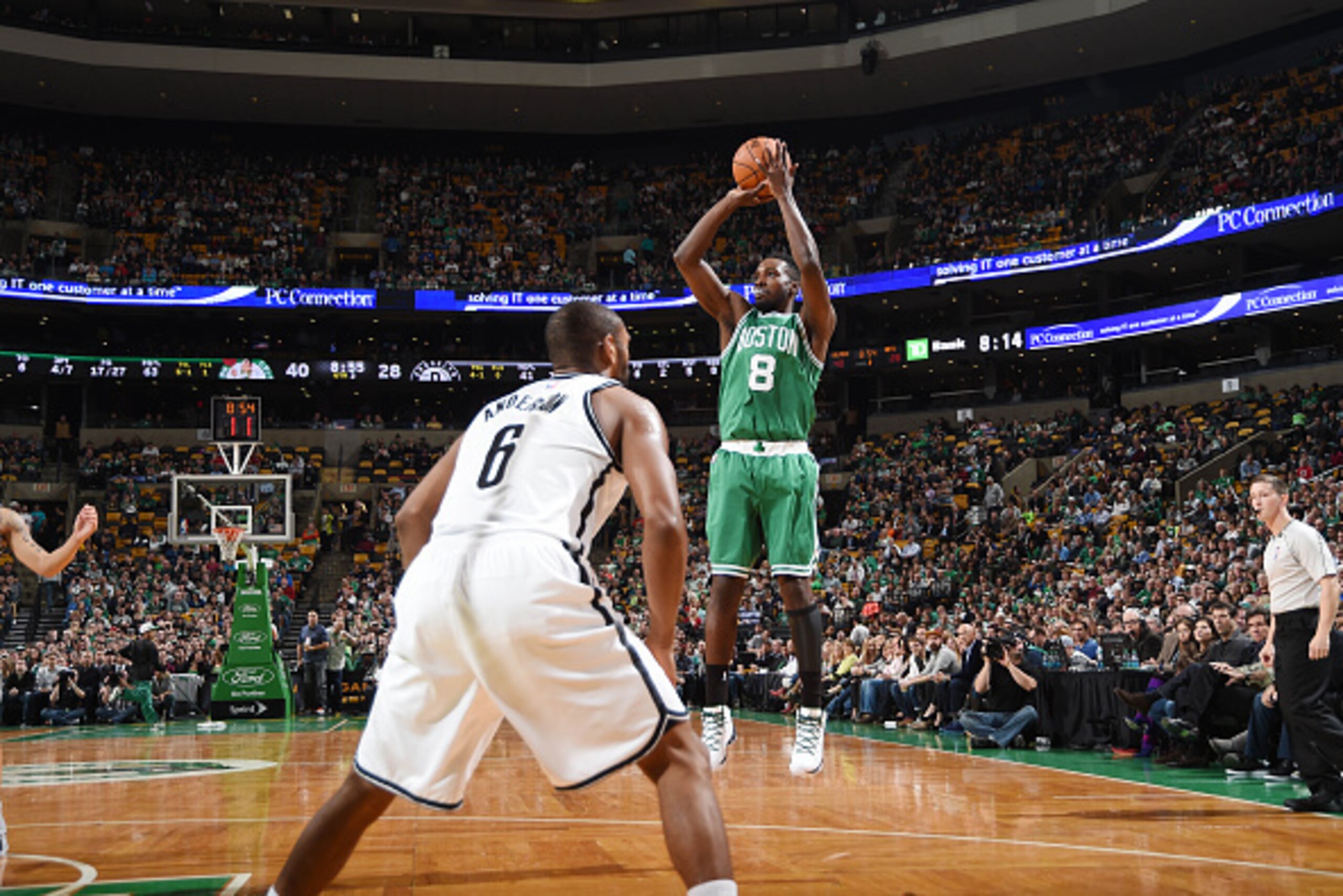 BOSTON, MA - OCTOBER 29: Jeff Green #8 of the Boston Celtics shoots against Alan Anderson #6 of the Brooklyn Nets during the game on October 29, 2014 at the TD Garden in Boston, Massachusetts. NOTE TO USER: User expressly acknowledges and agrees that, by 
