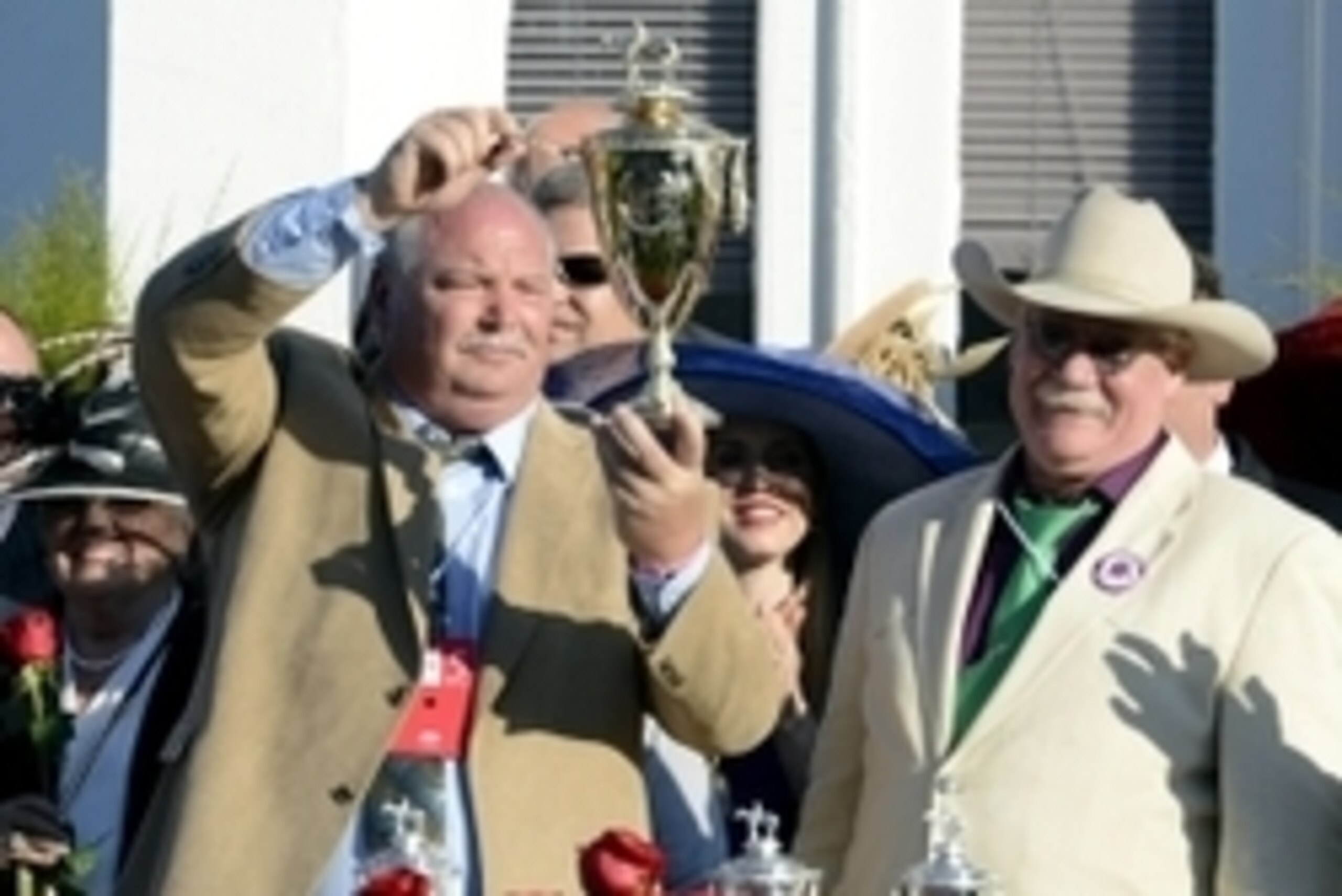 May 3, 2014; Louisville, KY, USA; California Chrome co-owners Perry Martin (left) and Steven Coburn (right) celebrate in the winner's circle after the 2014 Kentucky Derby at Churchill Downs. Mandatory Credit: Jamie Rhodes-USA TODAY Sports